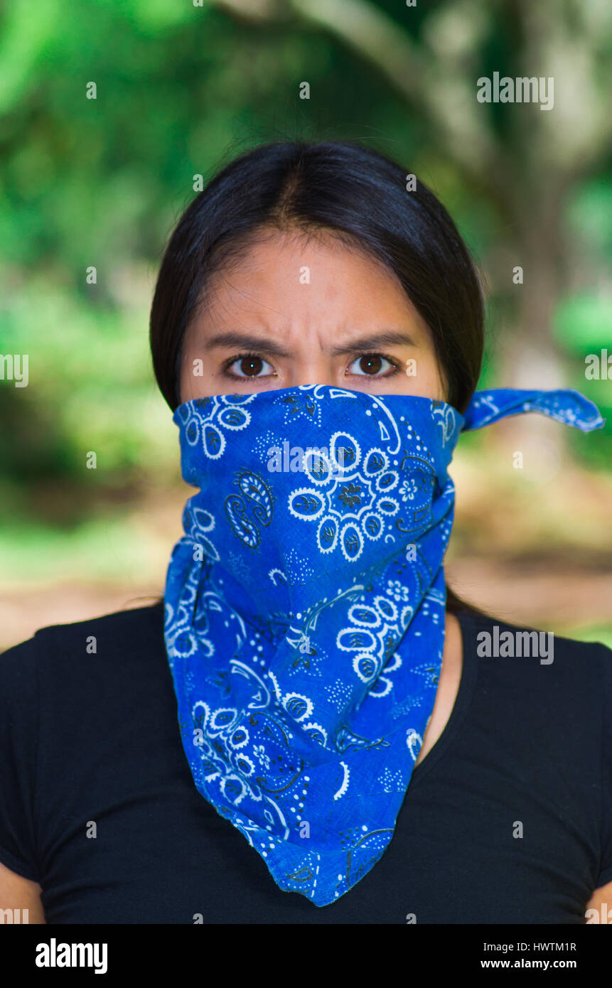 Young brunette woman wearing blue bandana covering half of face,  interacting outdoors for camera, activist protest concept Stock Photo -  Alamy