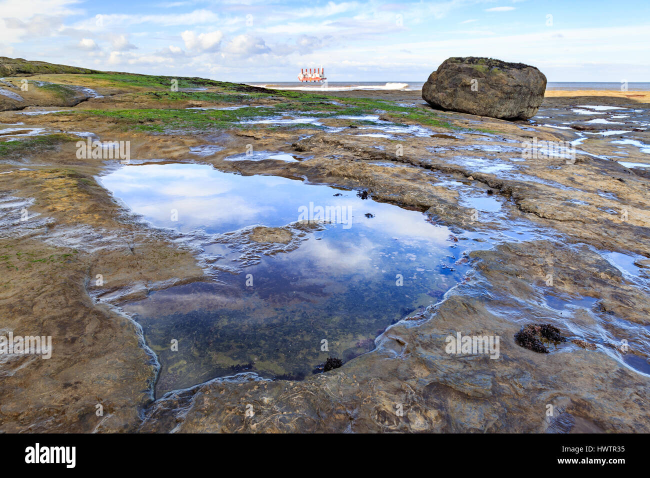 STAITHES, ENGLAND - MARCH 1: HDR image of Staithes beach and rockpools with 'MPI Resolution' offshore. In Staithes, North Yorkshire, England. On 1st M Stock Photo