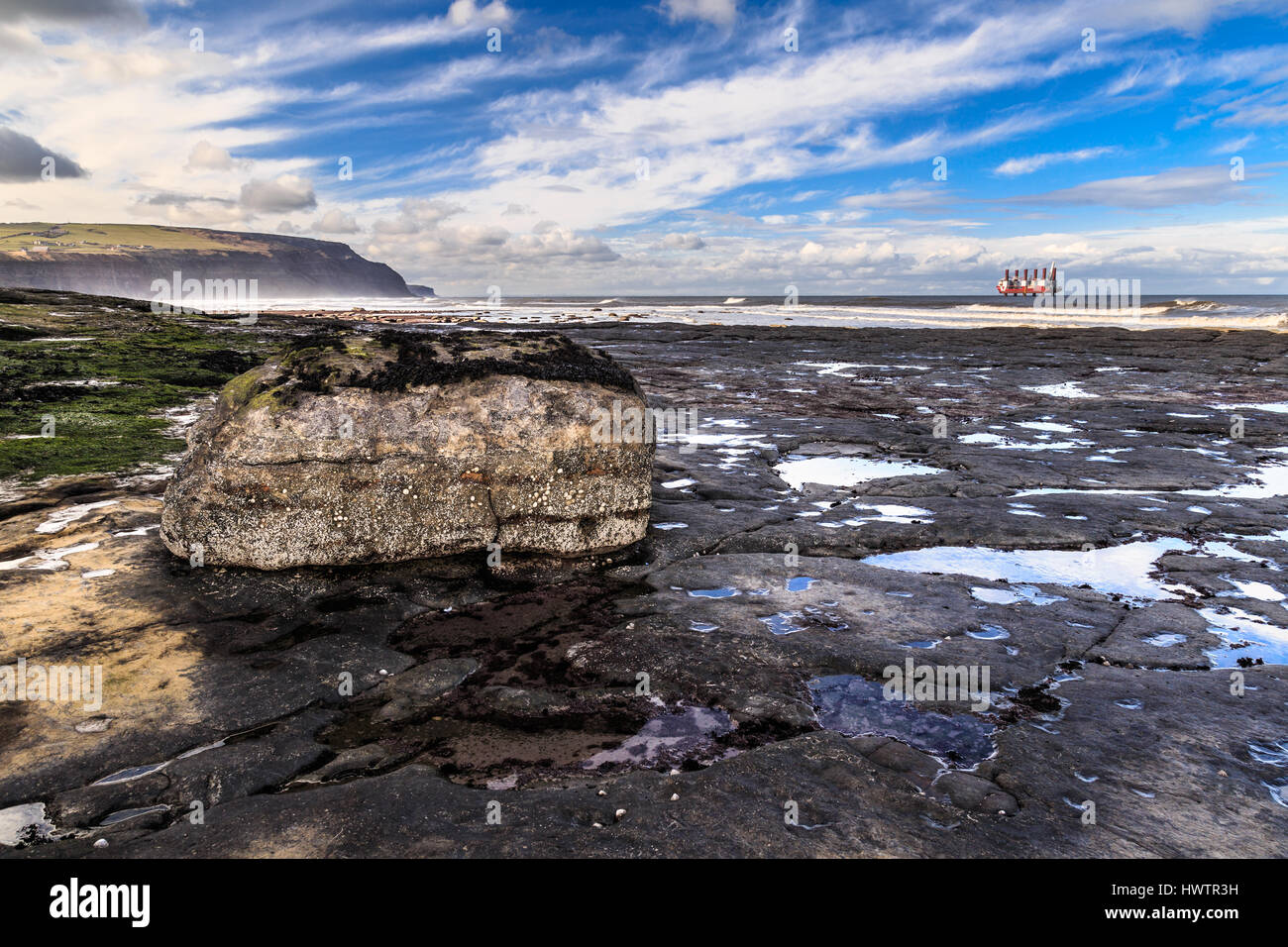 STAITHES, ENGLAND - MARCH 1: Large rock and rock pools on Staithes beach, North Yorkshire. In Staithes, North Yorkshire, England. On 1st March 2017. Stock Photo