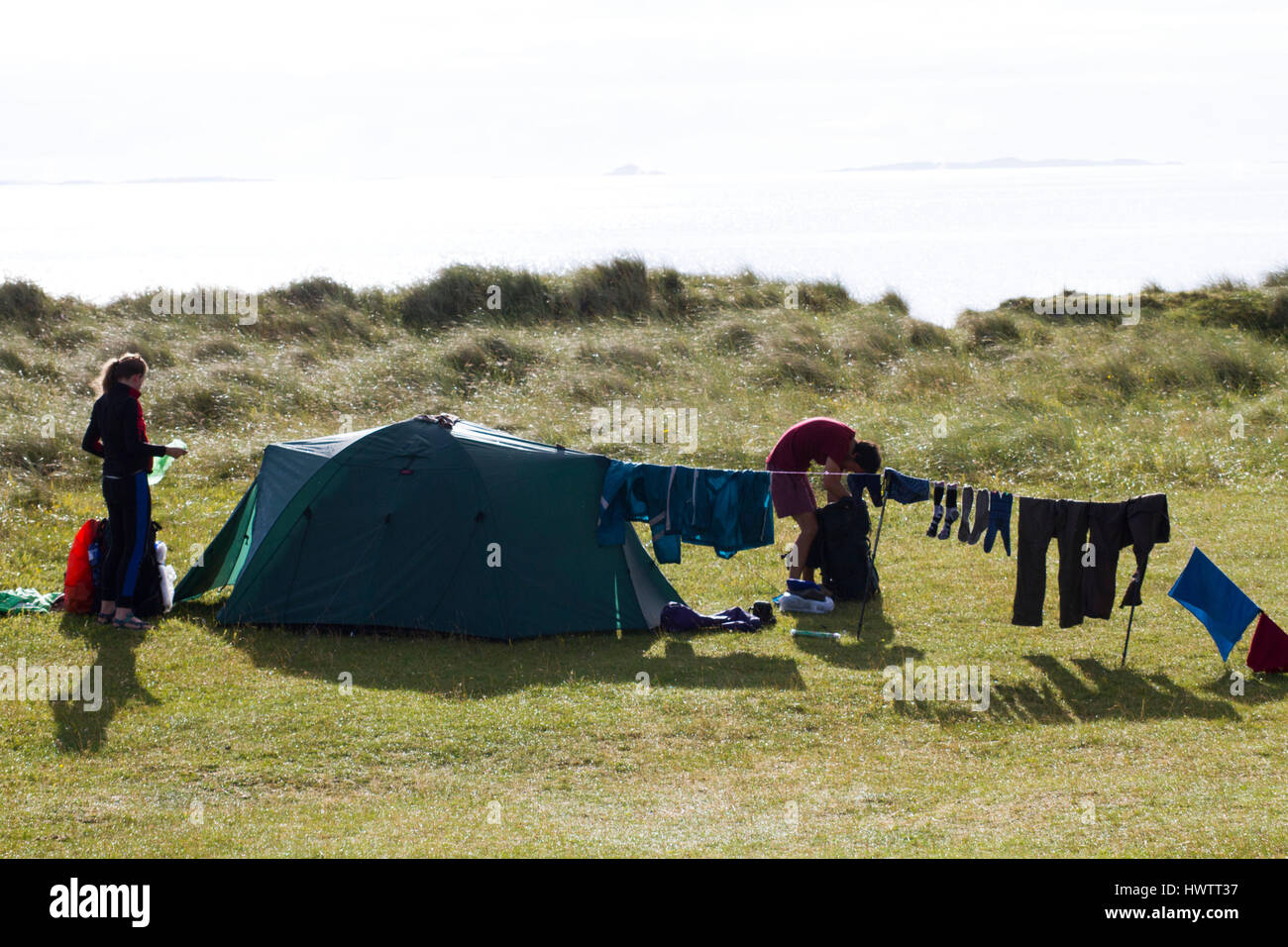 Couple camping on machir ,threat to nesting Terns and waders due to disturbance . Stock Photo