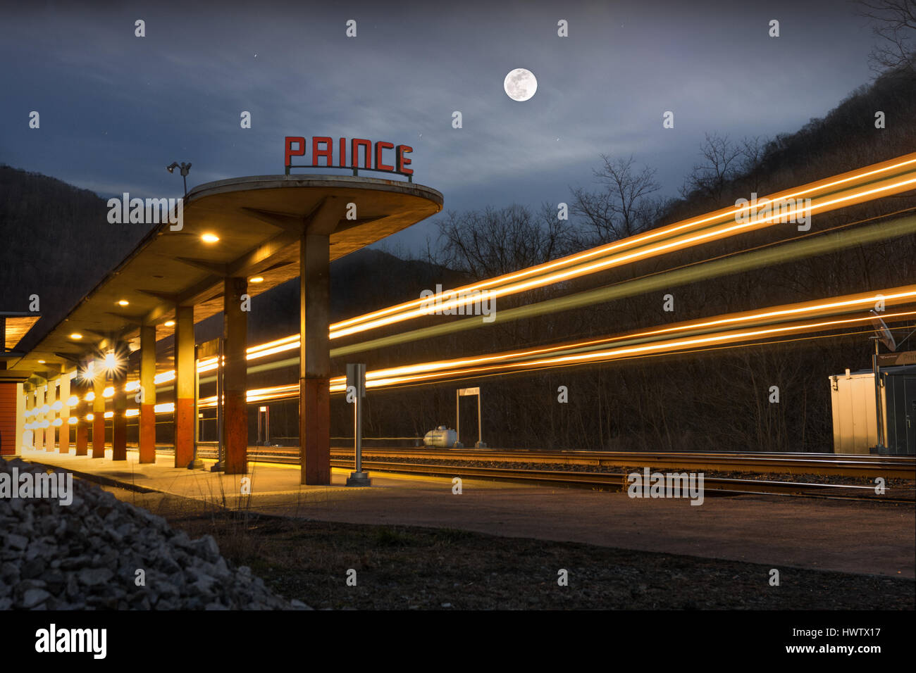 A train passes the old Amtrak station in the small town of Prince, West