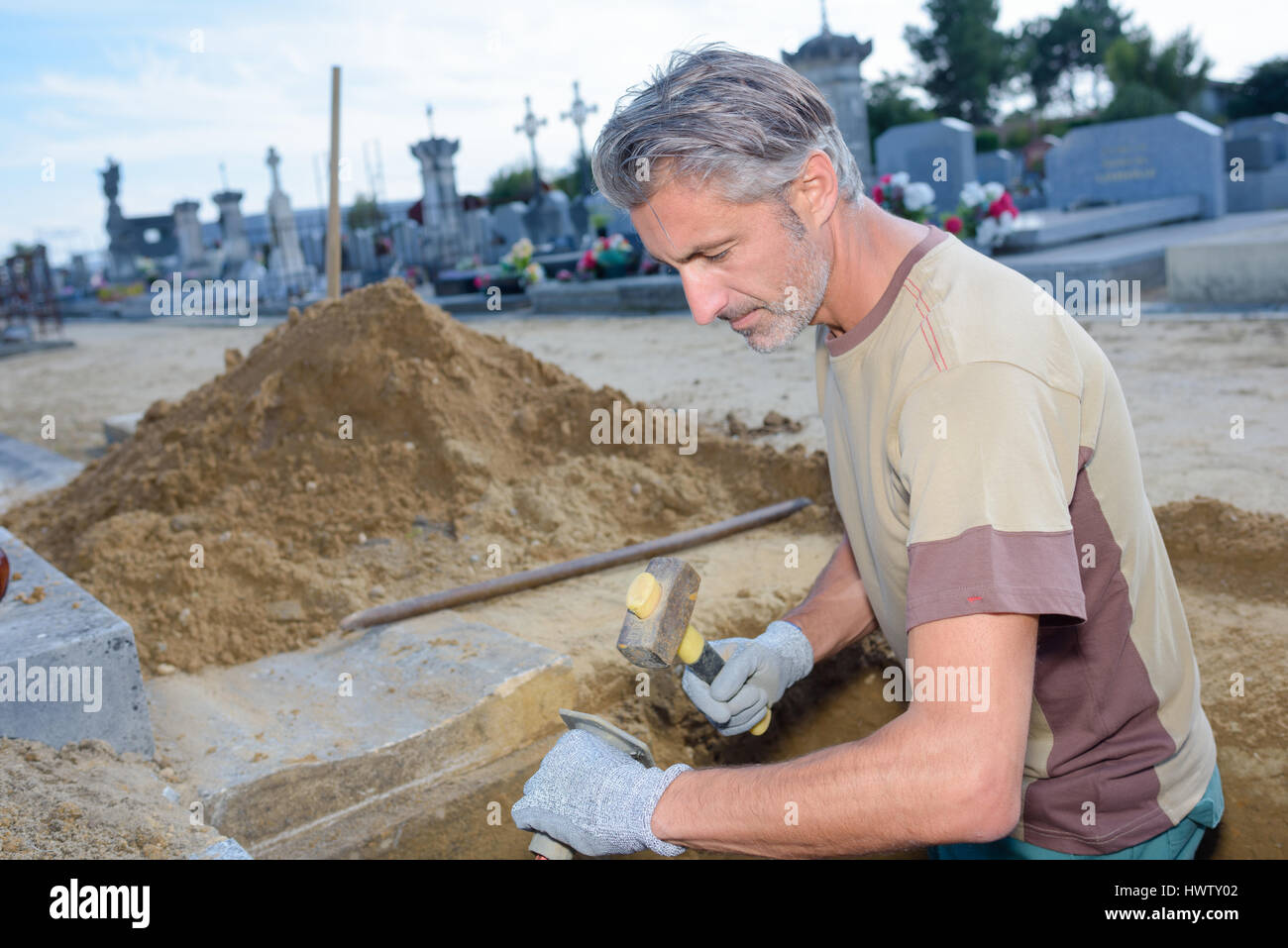 worker building a grave Stock Photo