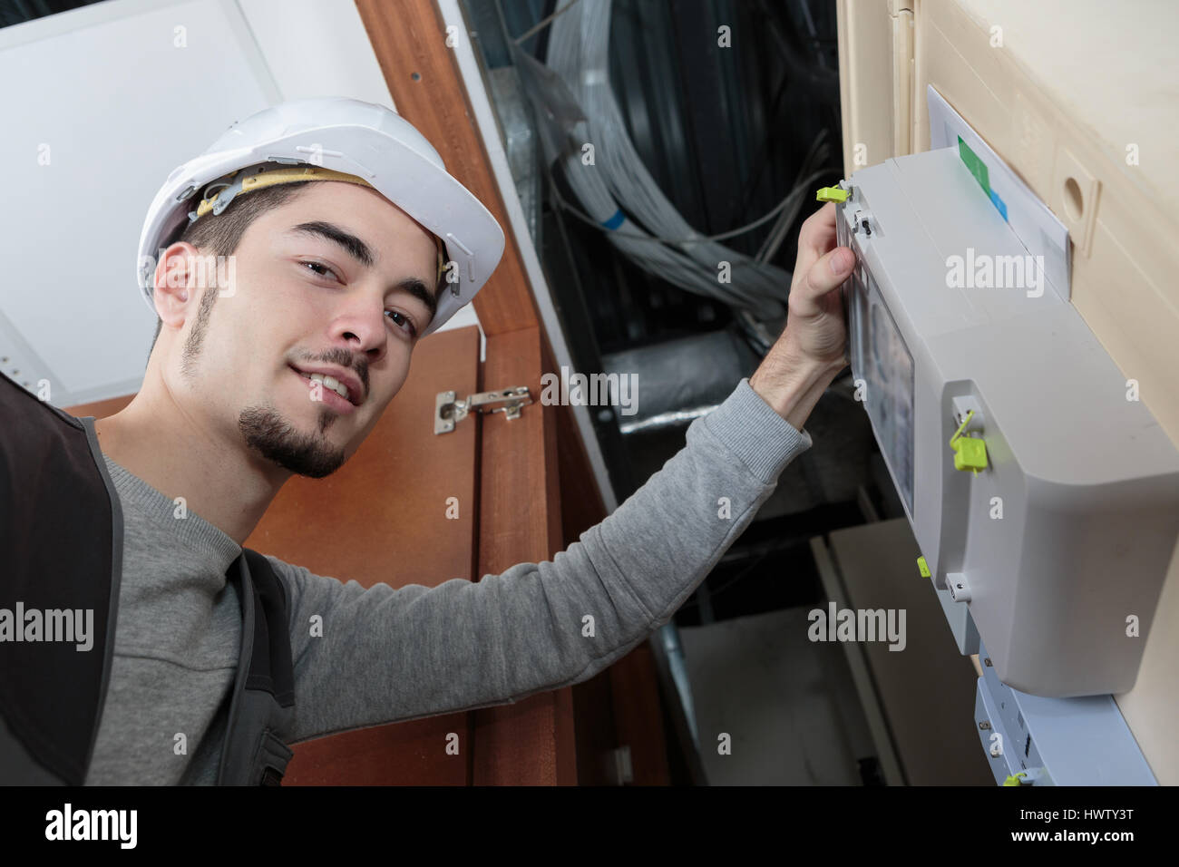 Portrait of man by electric meter Stock Photo