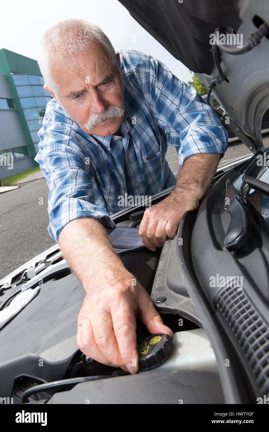 senior man checking the engine water level on car Stock Photo - Alamy