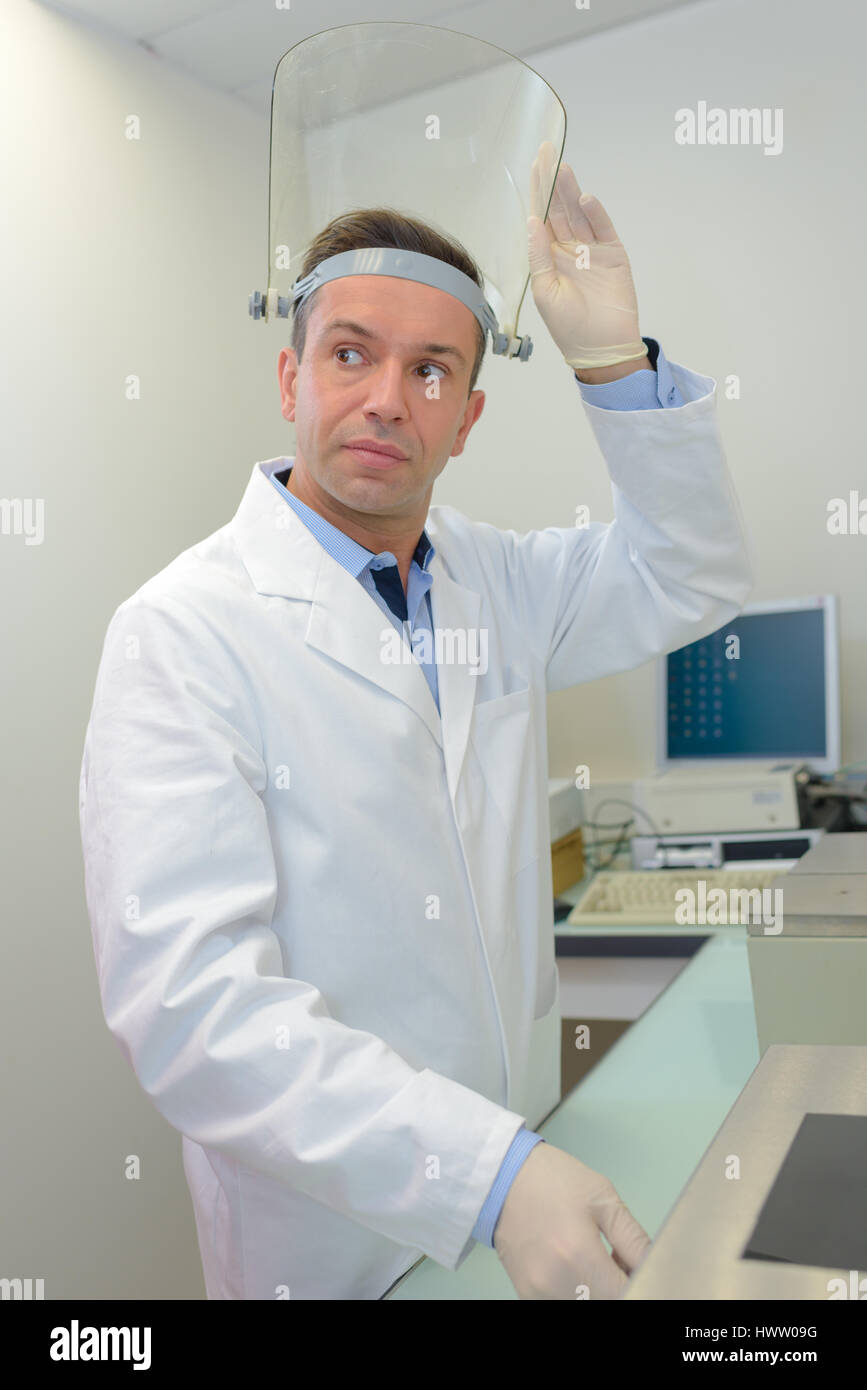 Lab technician wearing visor Stock Photo Alamy