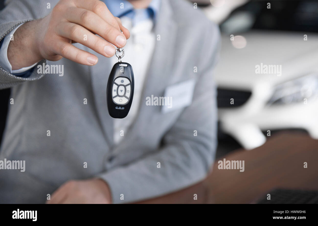 Low section of car salesman with car key Stock Photo