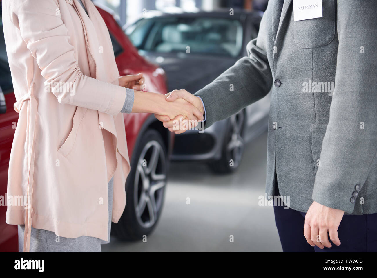 Close up of handshake salesman and woman Stock Photo