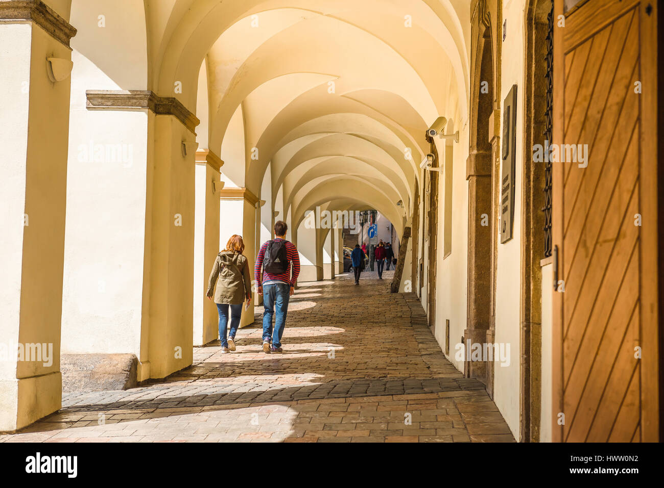 Prague old town arcade, a young couple walk through a typical medieval arcade in the historic Hradcany district of Prague, Czech Republic, Europe. Stock Photo