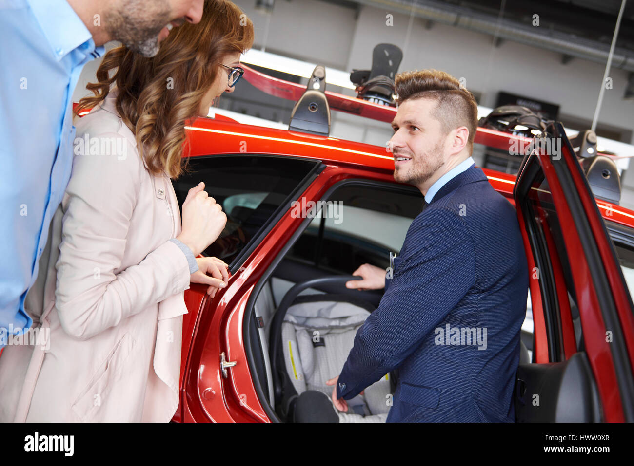 Salesman chatting about baby seat Stock Photo