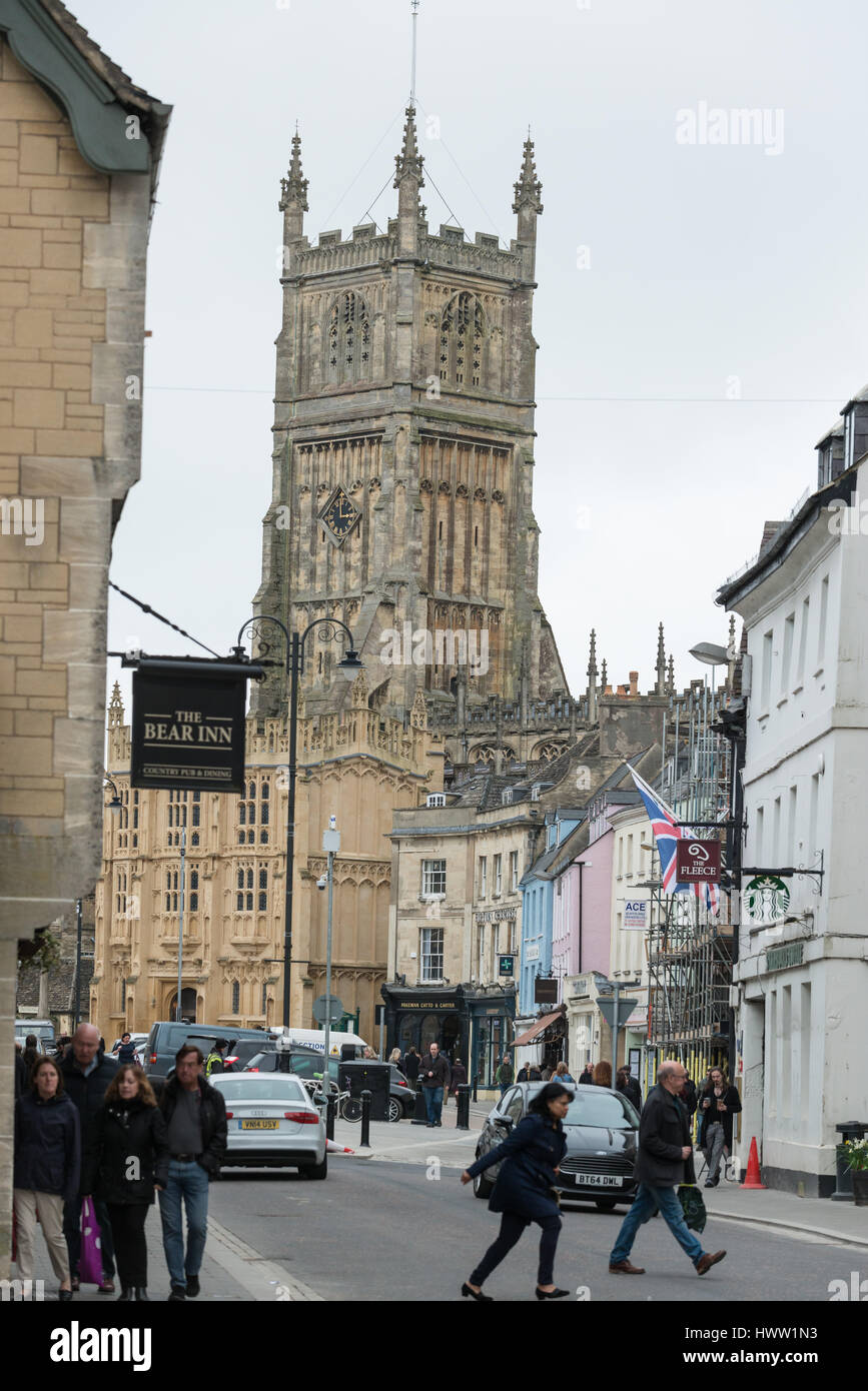 People walk down Black Jack Street with St John the Baptist parish church in the distance, Cirencester in the Cotswolds, Gloucester, England, UK Stock Photo