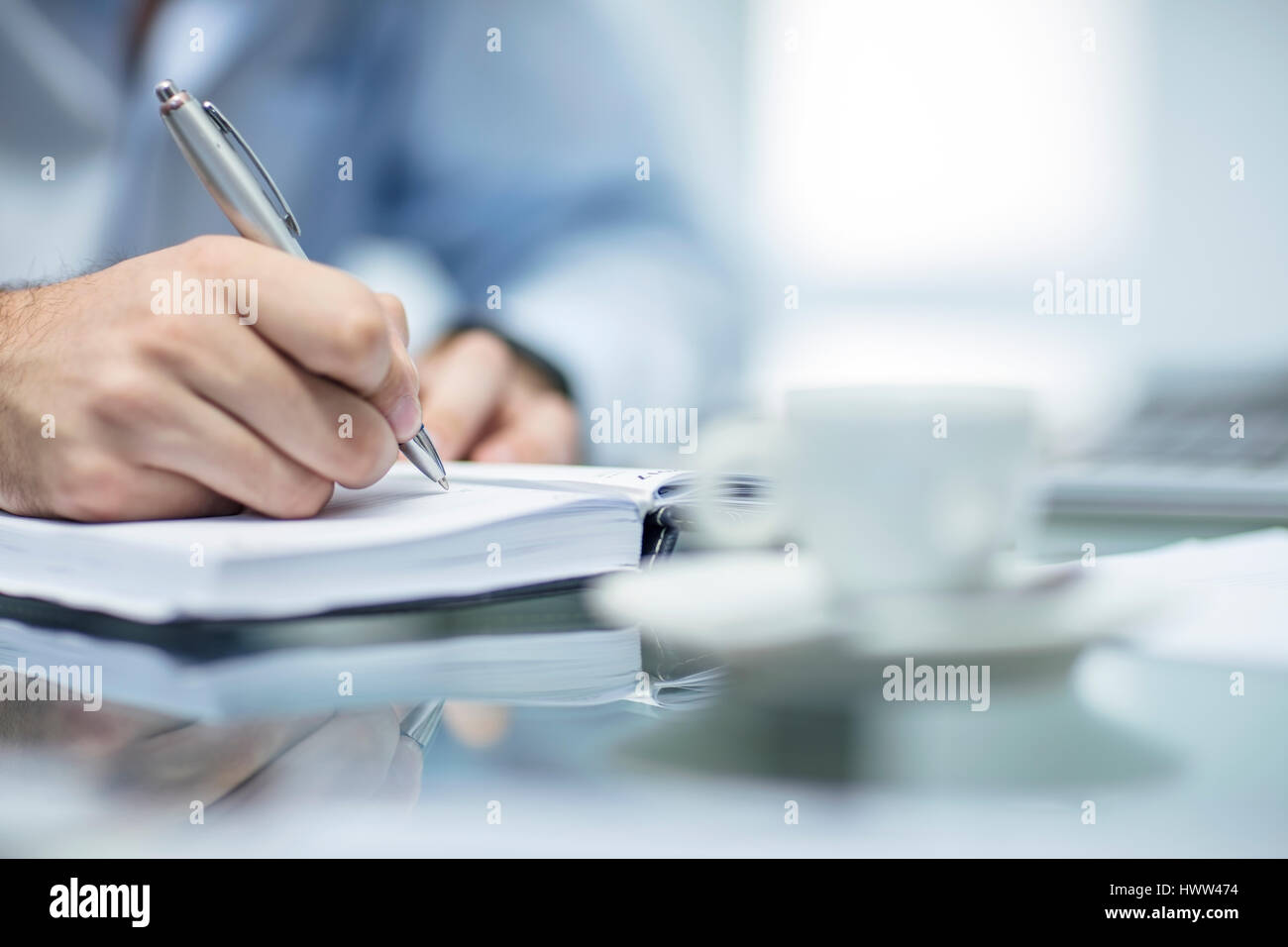 Person making notes in a dairy Stock Photo