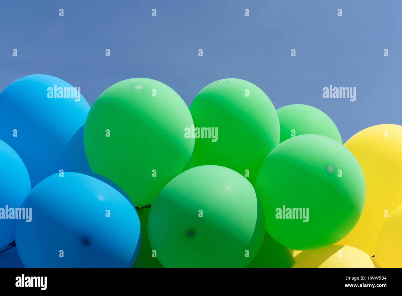 Multi colour balloons in a bunch floating in the sky Stock Photo - Alamy