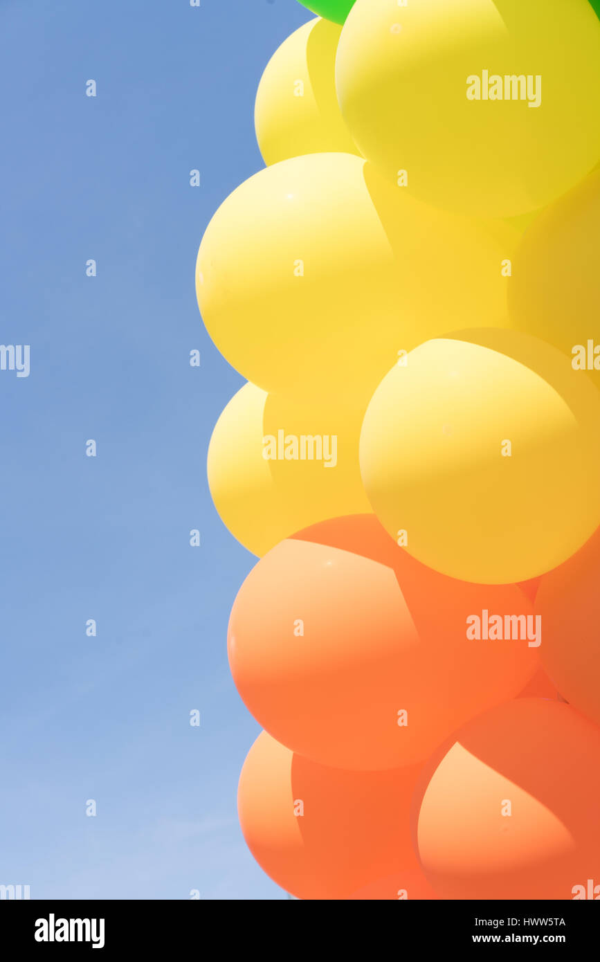 Multi colour balloons in a bunch floating in the sky Stock Photo - Alamy