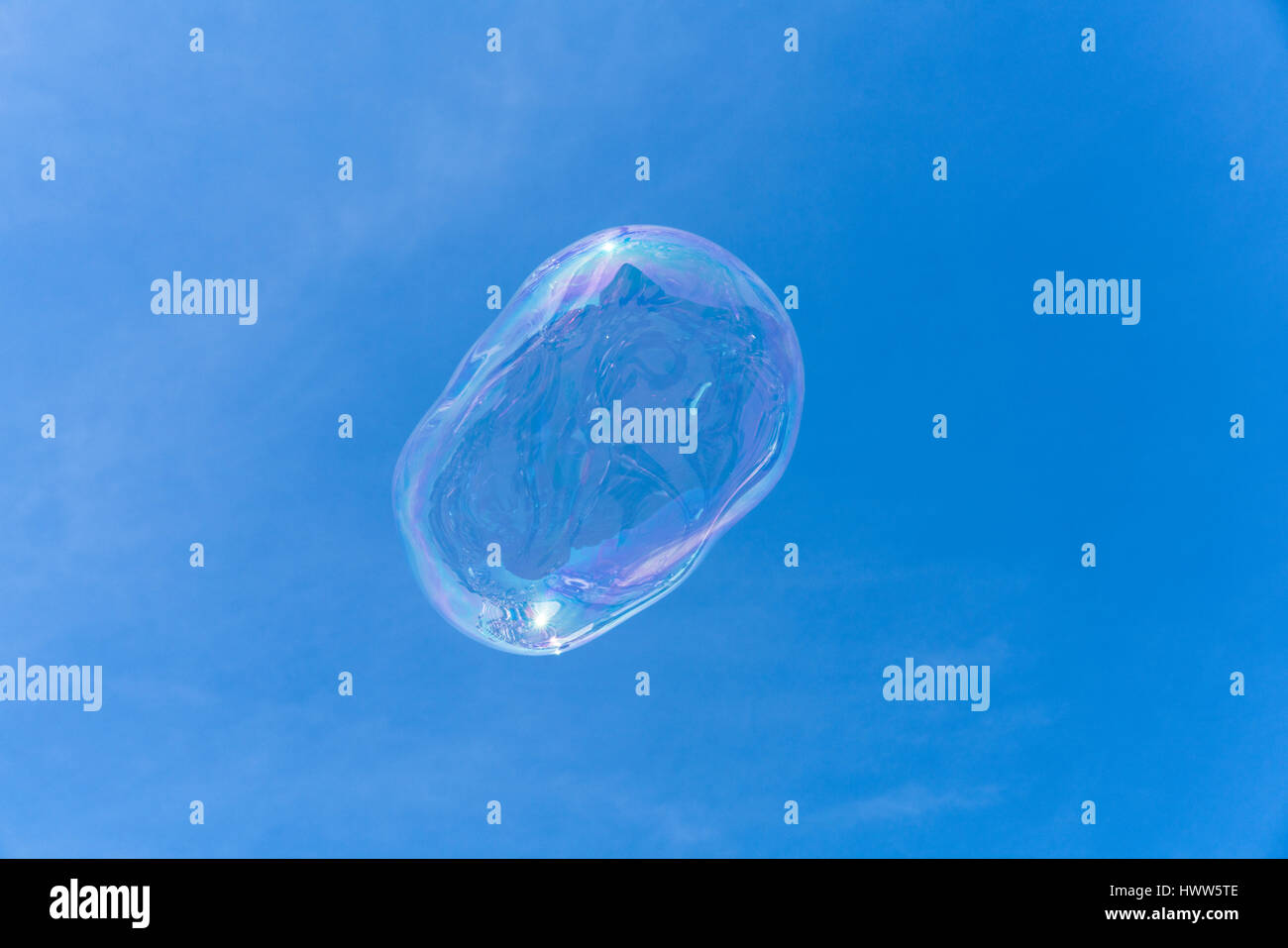 A soap bubble floating in the blue sky with reflections Stock Photo - Alamy