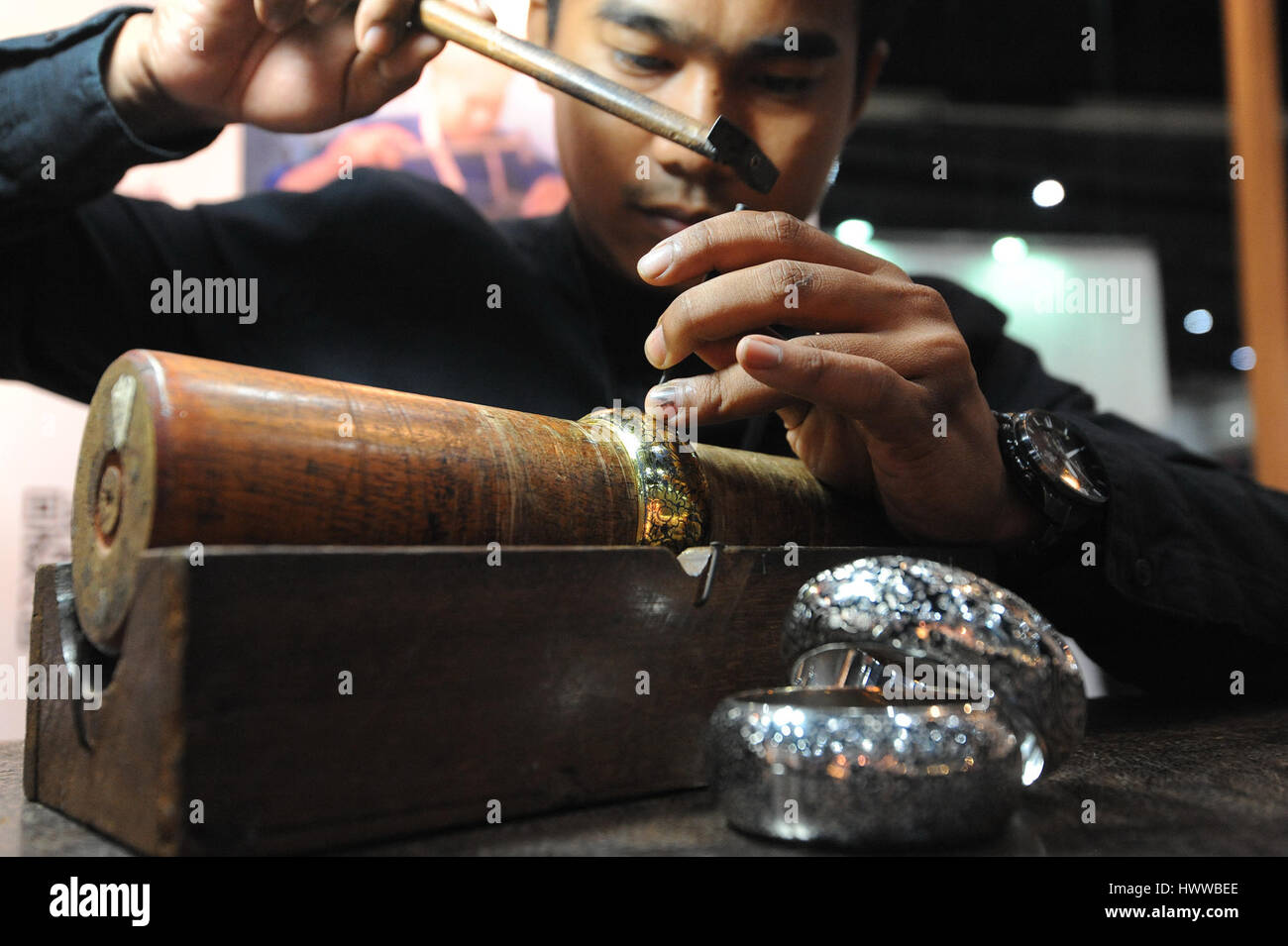 Bangkok, Thailand. 23rd Mar, 2017. A Thai jeweller works on a bracelet during the International Innovative Craft Fair 2017 at the Bangkok International Trade & Exhibition Centre in Bangkok, Thailand, March 23, 2017. A total of 350 arts and crafts exhibitors worldwide presented their skills and products as the International Innovative Craft Fair (IICF) 2017 began on Thursday in Bangkok. The four-day event aims to facilitate experience sharing among international craftspeople and promote related tradings. Credit: Rachen Sageamsak/Xinhua/Alamy Live News Stock Photo