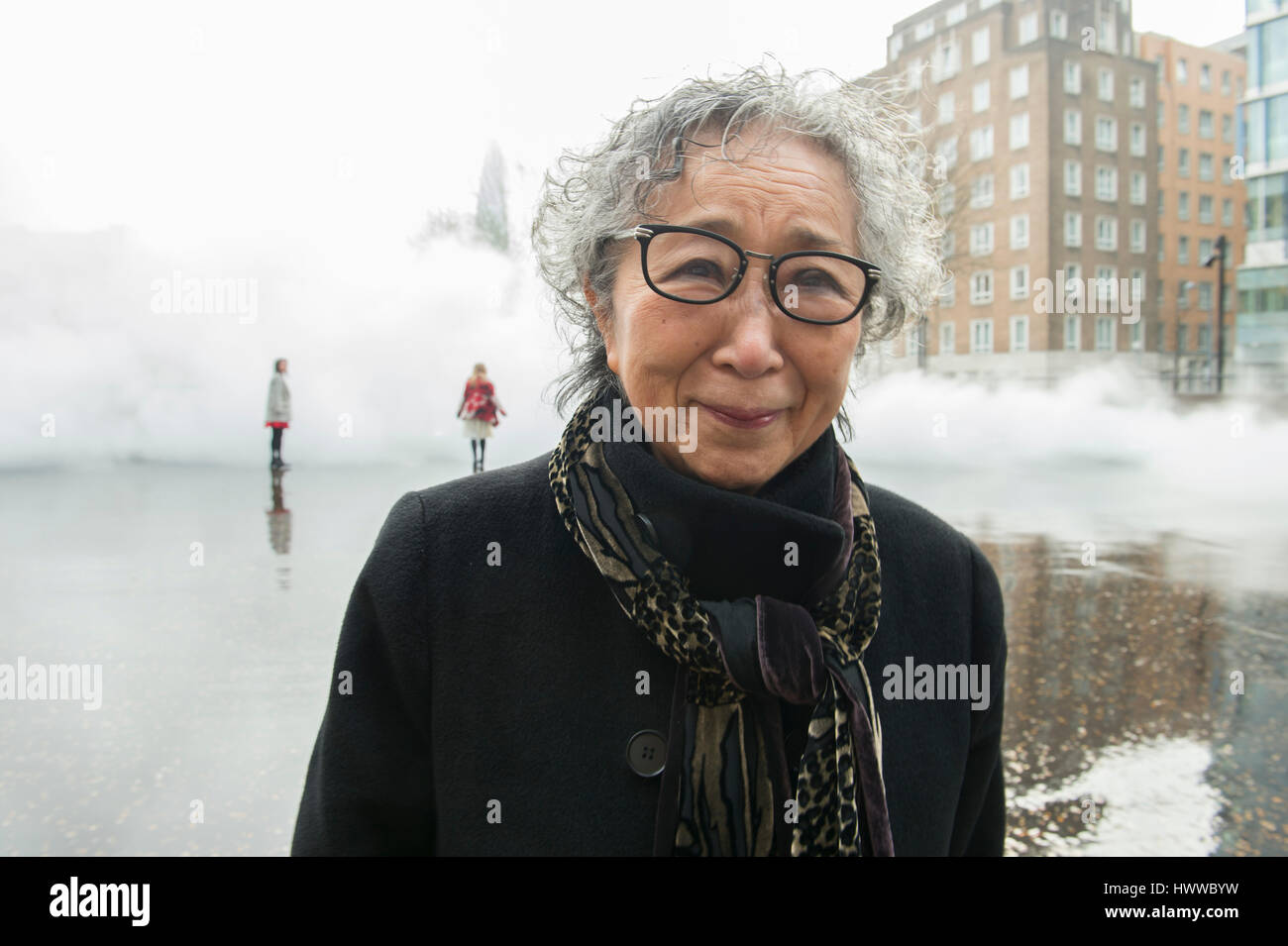 Tate Modern, London, UK. 23rd March 2017. BMW Tate Live exhibition, Ten Days Six Nights. Fujiko Nakaya fog sculpture debuts outside Tate Modern’s Switch House, with the artist pictured. Credit: Malcolm Park editorial/Alamy Live News. Stock Photo
