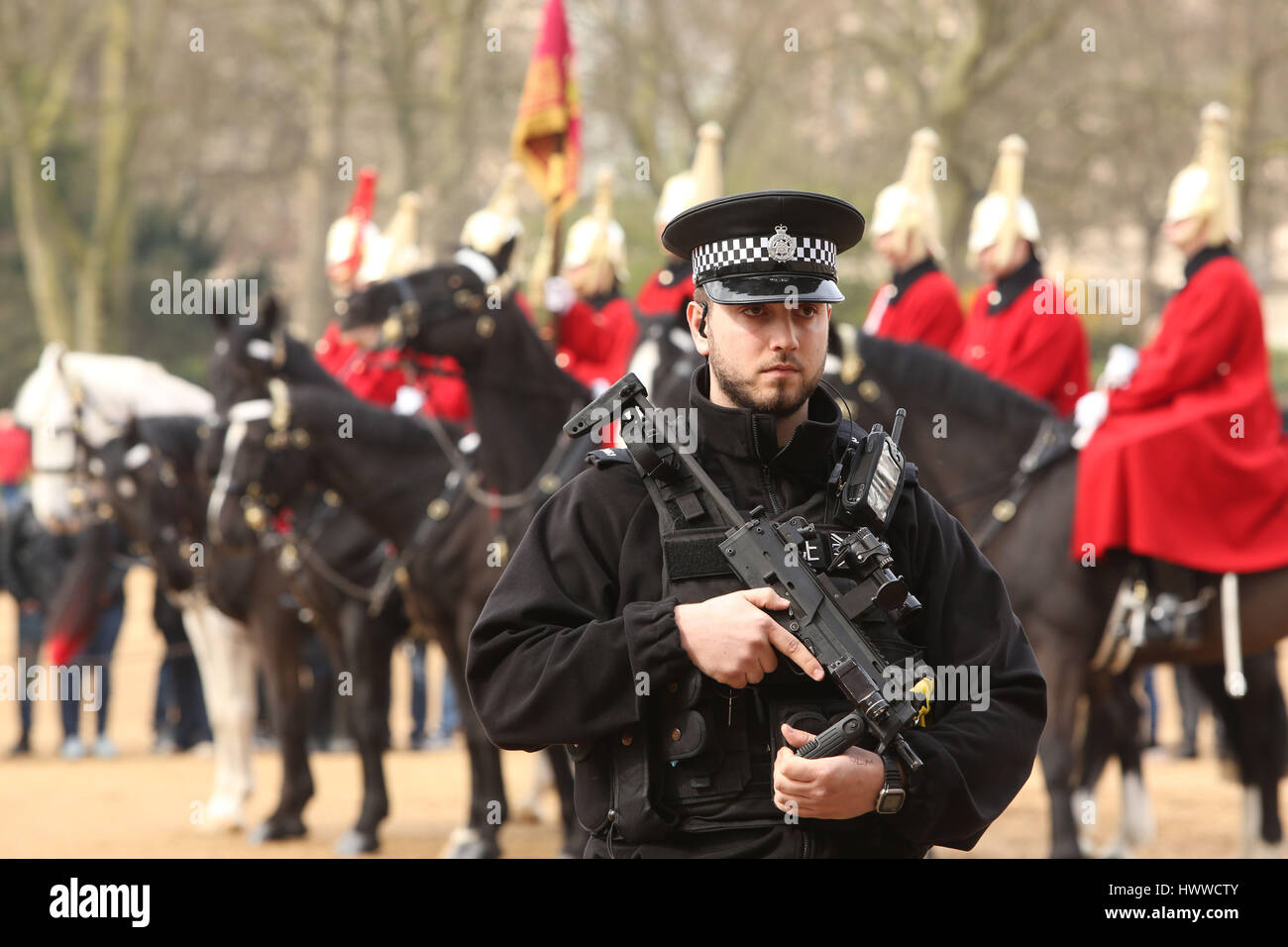London, UK. 23rd March 2017.   Armed Police watch over mounted soldiers and tourists on Horse Guards Parade. Credit: Nigel Bowles/Alamy Live News Stock Photo