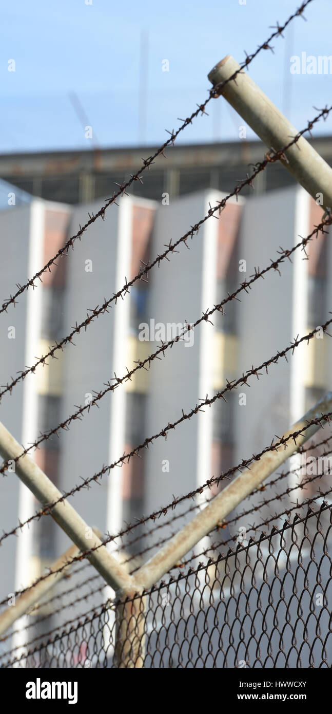 Stuttgart, Germany. 23rd Mar, 2017. Barbed wire can be seen in front of the penitentiary in Stuttgart, Germany, 23 March 2017. In the face of growing numbers of inmates state minister of justice Wolf has decided to continue the use of the infamous high-rise prison of Stuttgart-Stammheim. Photo: Franziska Kraufmann/dpa/Alamy Live News Stock Photo
