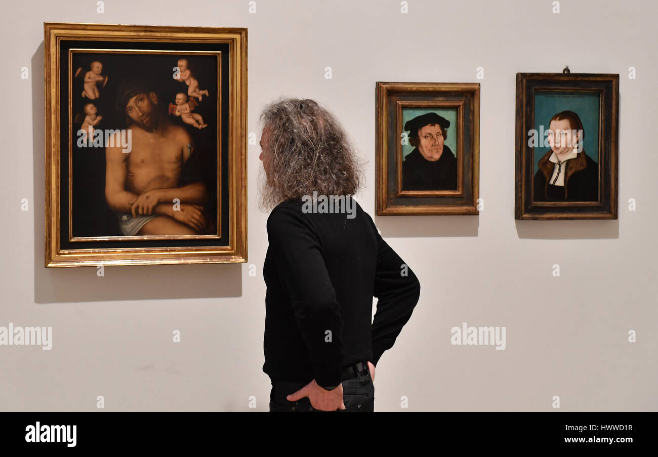 Erfurt, Germany. 23rd Mar, 2017. Kai Uwe Schierz, director of the Art Museums Erfurt at the exhibition 'Cranach before and after the reformation' at the Angermuseum in Erfurt, Germany, 23 March 2017. The paintings (L-R), 'Schmerzensmann zwischen Engeln', 'Bildnis Martin Luthers' and 'Bildnis der Katharina Luther', which were fashioned after Cranach, or produced in his workshop. The exhibition shows rare pictures, partially from private collections, of Lucas Cranach from the 25th March to the 25th June. Photo: Martin Schutt/dpa-Zentralbild/dpa/Alamy Live News Stock Photo