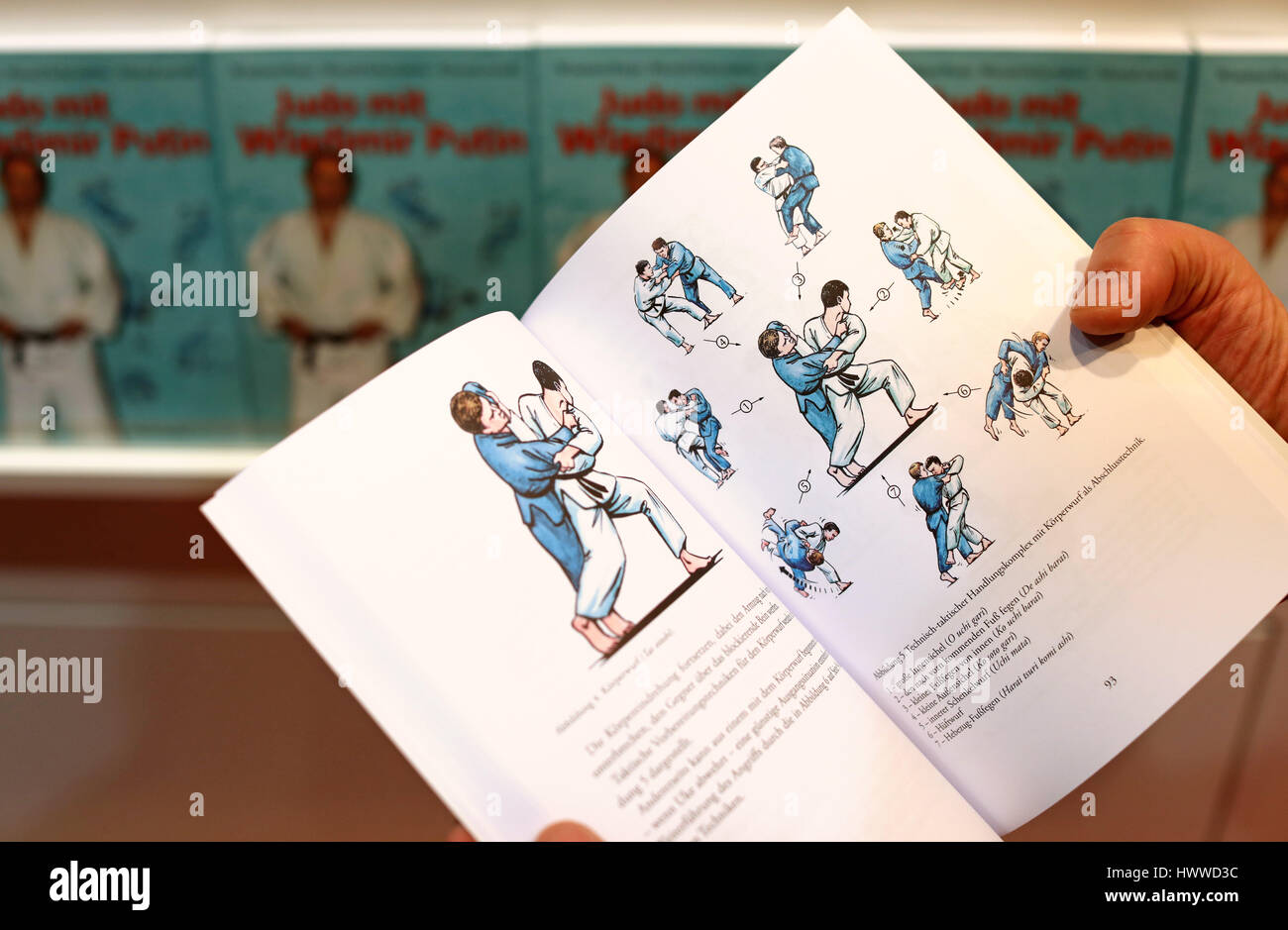 The opened book 'Judo with Vladimir Putin' can be seen at the book fair in Leipzig, Germany, 23 March 2017. With 221 pages and 77 coloured illustrations, Judo techniques are easily explained. The Russian president is an athlete with the 9th dan and practies Judo often. Starting 23 March Leipzig becomes once more for four days the Mecca for authors, publishers and bibliophiles. Around 3400 presentations will take place in 570 stages until 26 March. Lithuania is under focus as a guest country. Last year the fair saw about 260 000 visitors. Photo: Jan Woitas/dpa-Zentralbild/dpa Stock Photo
