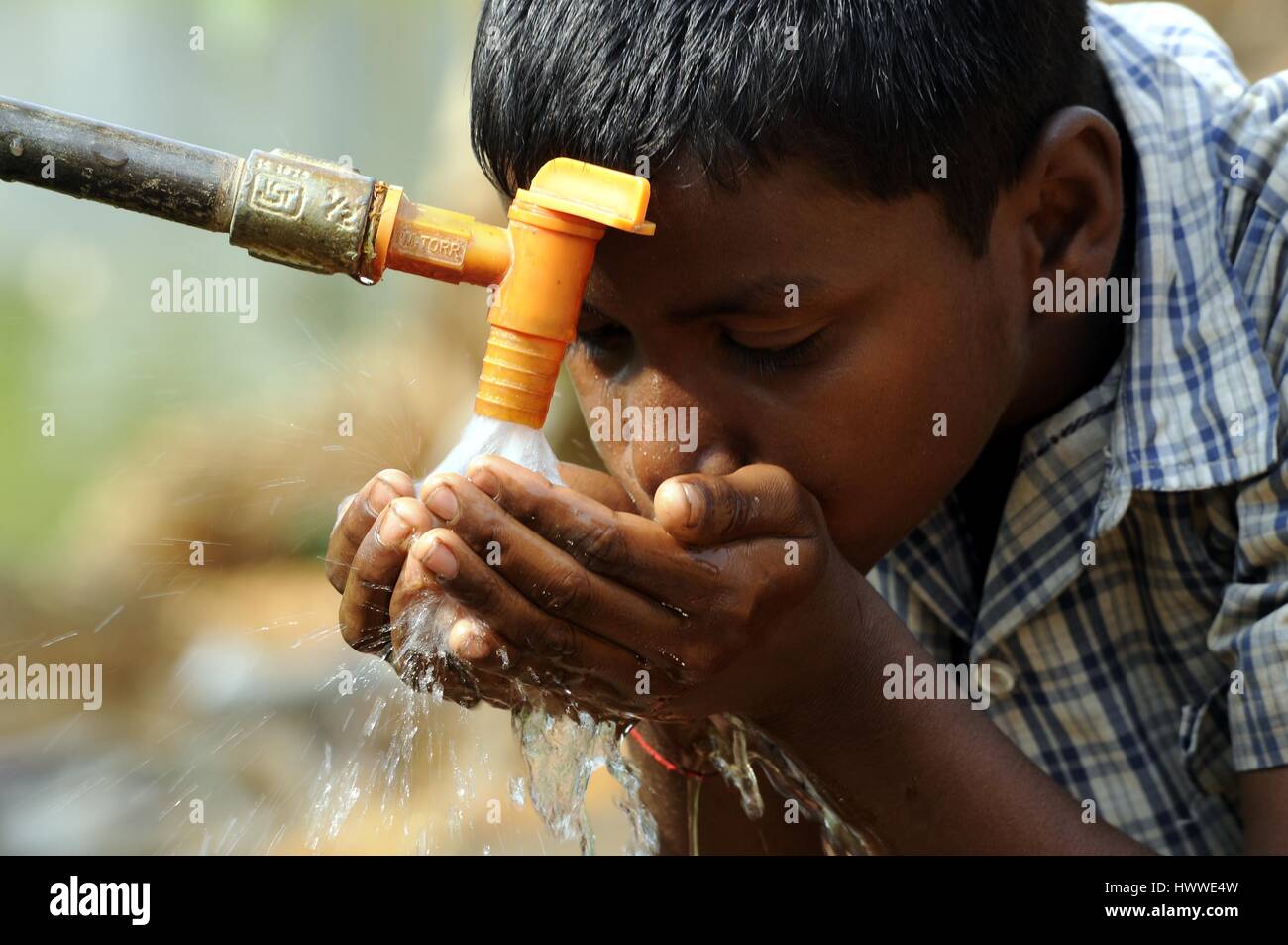 World Water Day in India -  21/03/2017  -  India / Tripura / Agartala  -  An Indian school children drinks water from a water supply line on the eve of World water day at Raimura village, on the outskirts of Agartala, the capital of northeastern state of Tripura on March 21, 2017. World Water Day is observed on March 22 every year.   -  Abhisek Saha / Le Pictorium Stock Photo