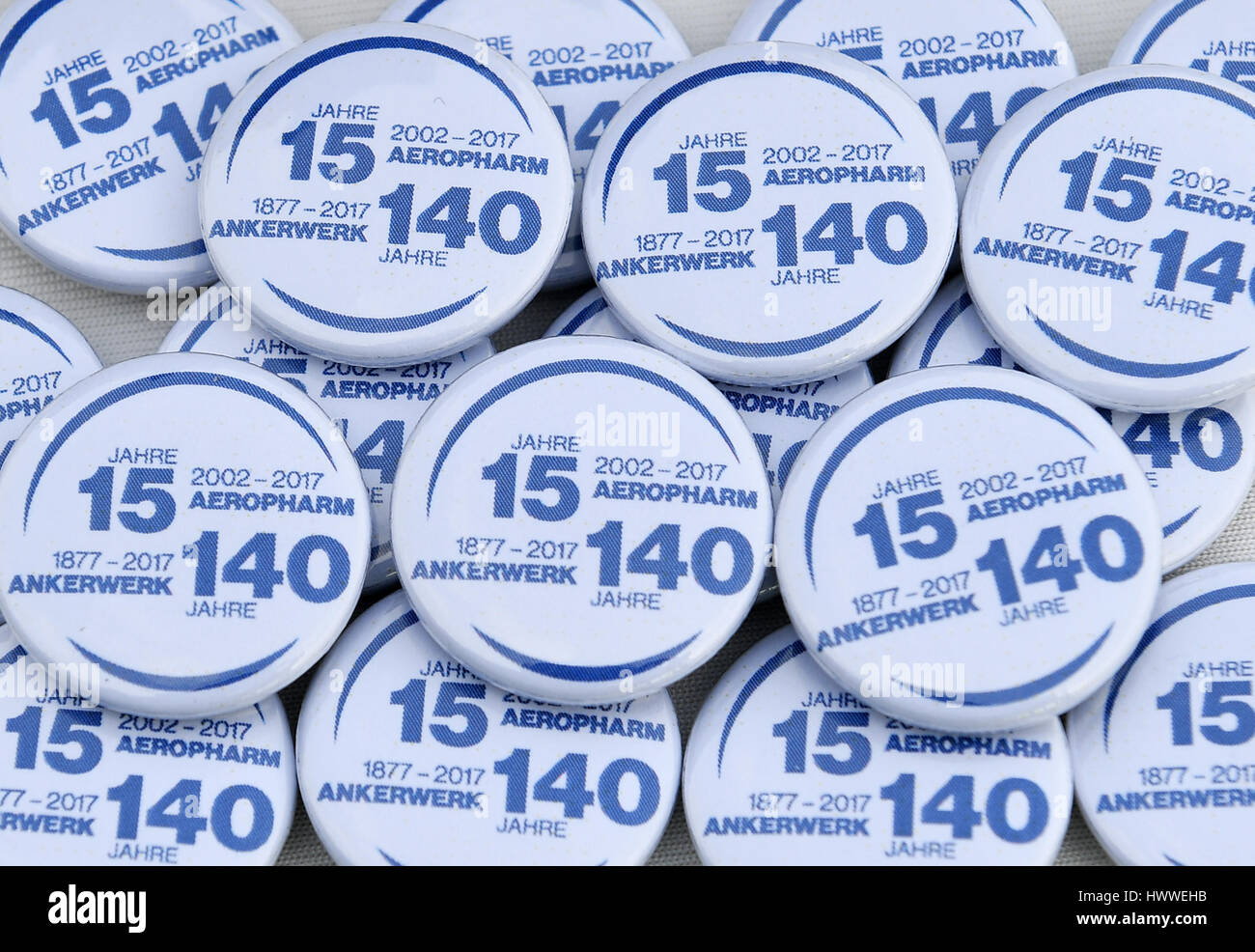 Buttons for the celebration of the anniversary of the Aeropharm GmbH in Rudolstadt, Germany, 15 March 2017. The 15th anniversary of the company was celebrated on the same day. The company, now part of the pharma group Novartis, derrived from the former VEB Ankerwerk and its successor. It produces asthma pharmaceuticals and eye drops that are exported to more than 50 countries. Photo: Martin Schutt/dpa-Zentralbild/dpa Stock Photo