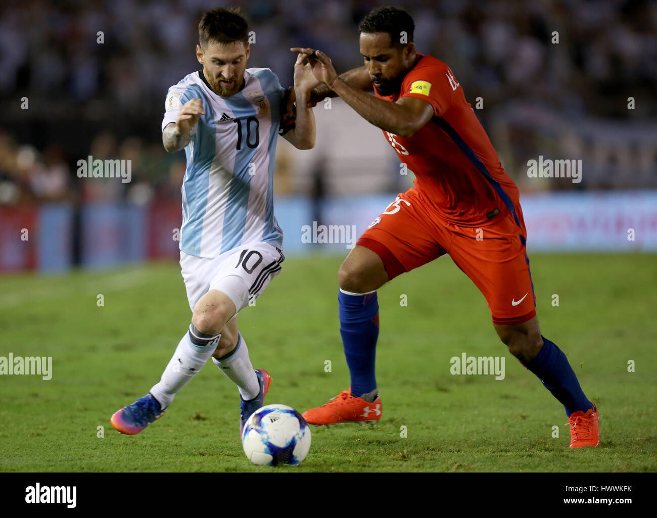 Buenos Aires, Argentina. 23rd Mar, 2017. Argentina's Lionel Messi (L) vies for the ball with Chile's Jean Beausejour (R) during the match for the South American qualifiers for the Russia 2018 FIFA World Cup, held in the Antonio Vespucio Liberti stadium, Buenos Aires, Argentina, on March 23, 2017. Credit: Martin Zabala/Xinhua/Alamy Live News Stock Photo