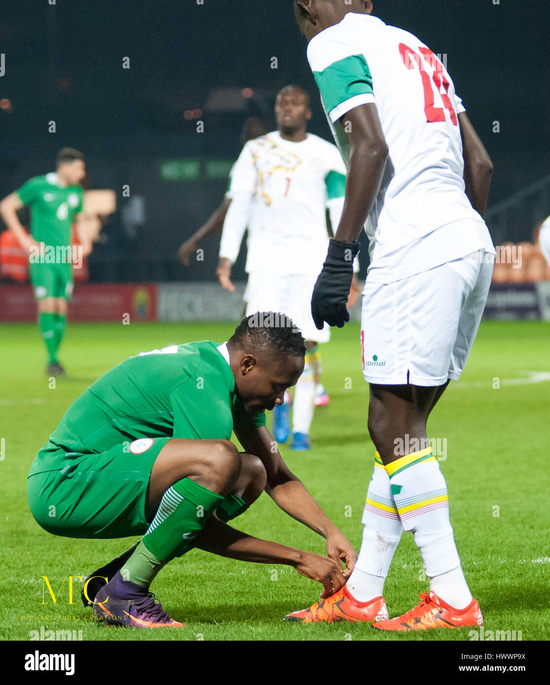 The Hive, Barnet,  England. 23rd March 2017. Ahmed Musa of Nigeria ties the boot lace of Adama Mbengue of Senegal during the International Friendly match between Nigeria and Senegal. Michael Tubi / Alamy Live News Stock Photo