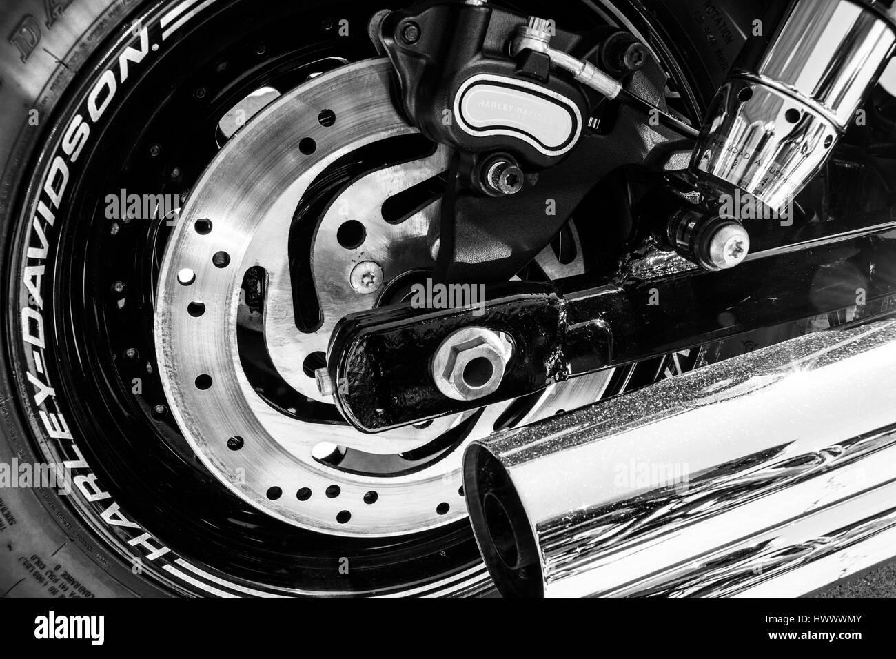 Indianapolis - Circa March 2017: Rear Tire, Brake Rotor and Exhaust Pipe of a Harley Davidson. Harley Davidson Motorcycles are Known for Their Loyal F Stock Photo
