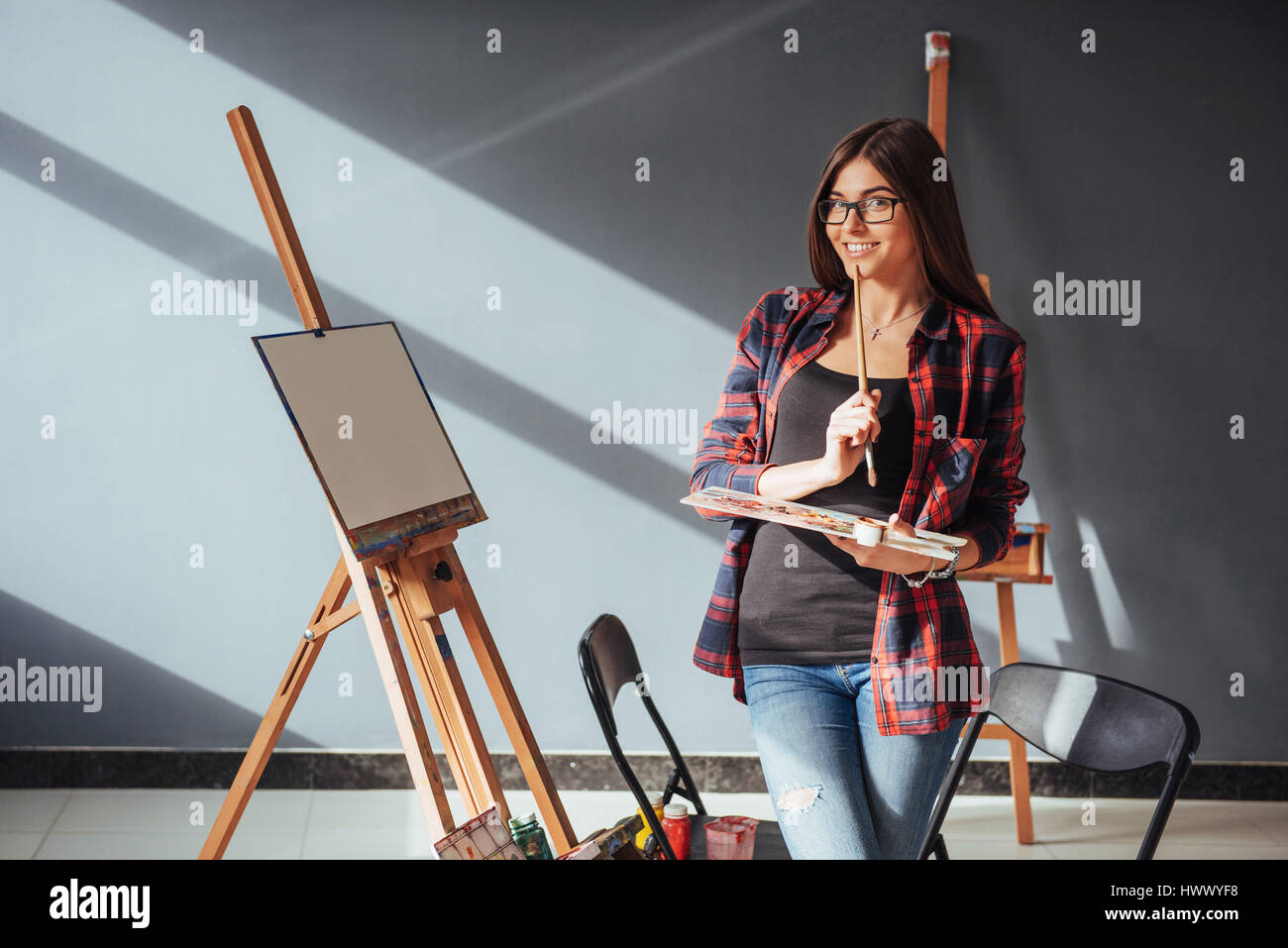 Young woman artist painting a picture in studio Stock Photo - Alamy