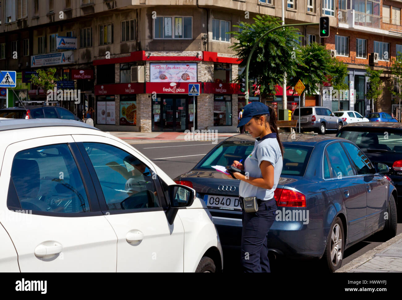 Female traffic warden issuing a parking ticket in Santander Cantabria Spain Stock Photo