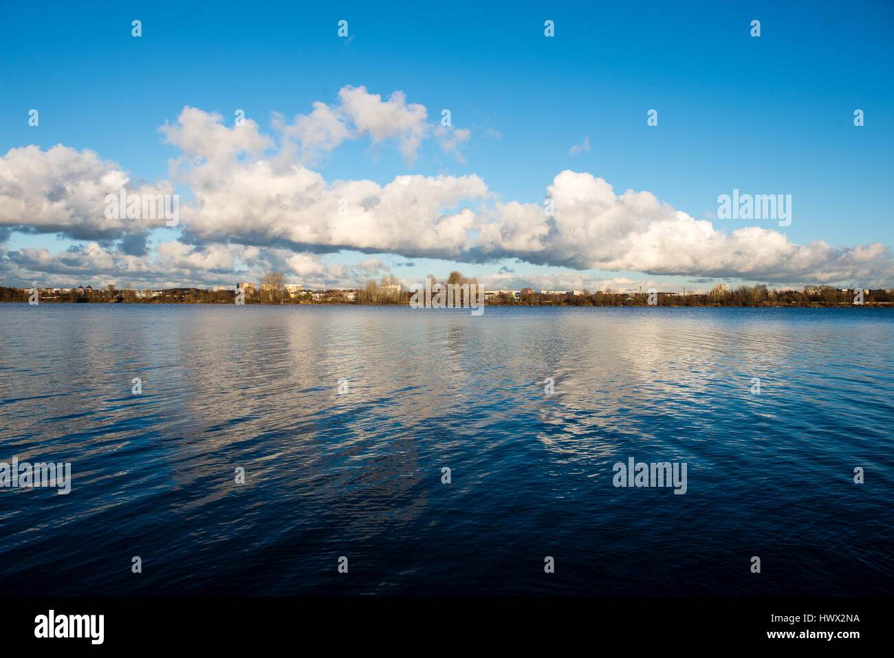 White clouds over the river with blue sky and city skyline Stock Photo ...