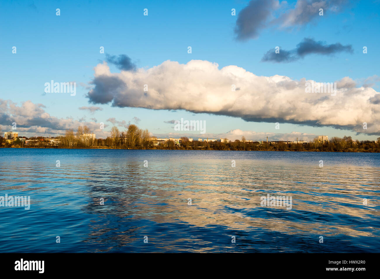White clouds over the river with blue sky and city skyline Stock Photo ...