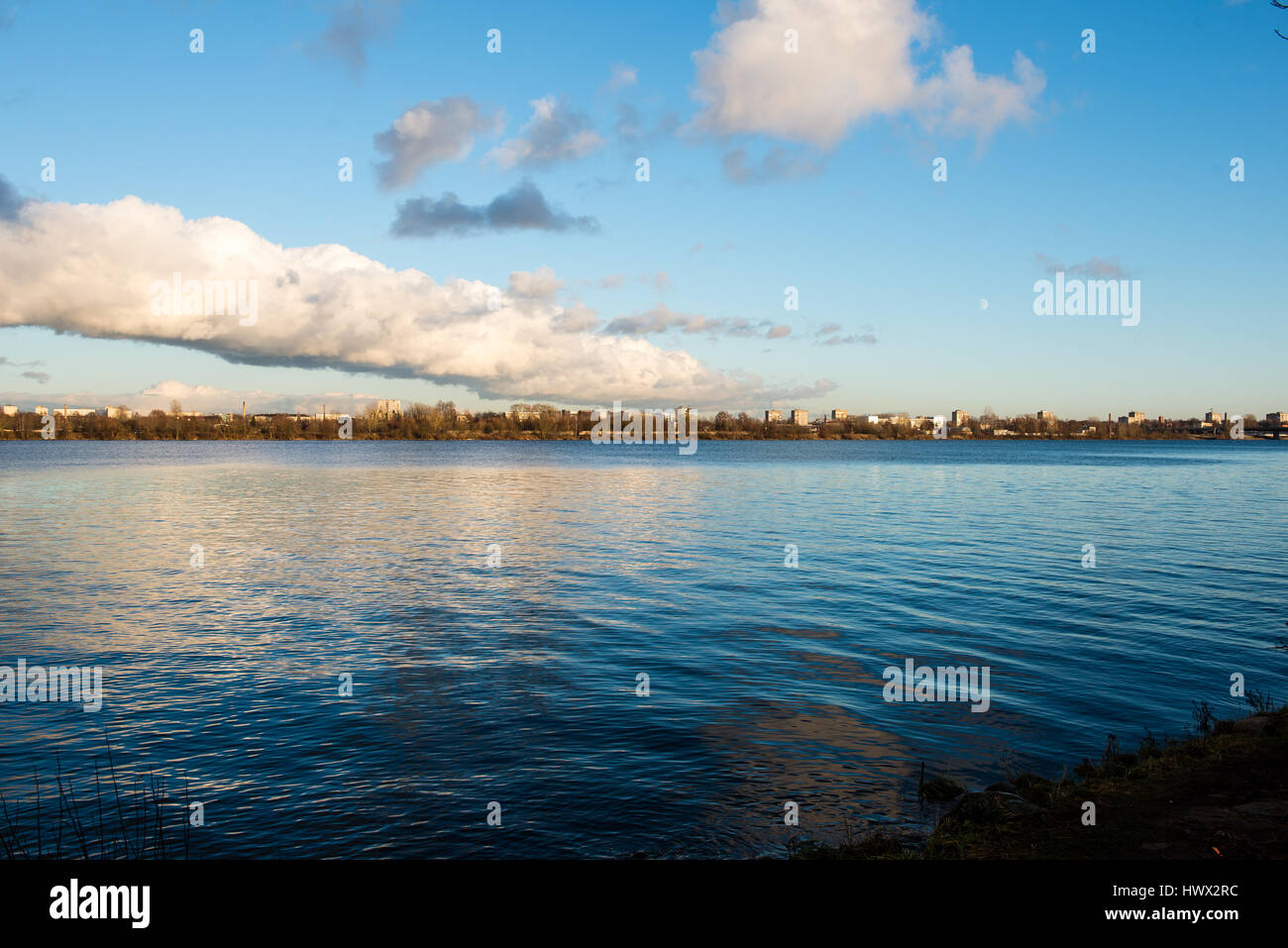 White clouds over the river with blue sky and city skyline Stock Photo ...