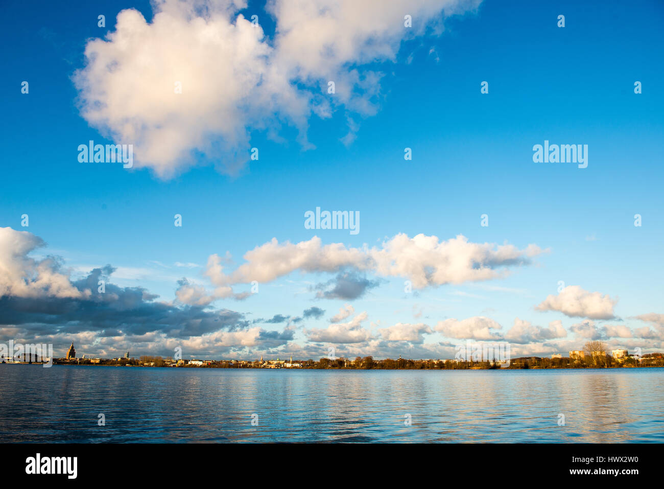 White clouds over the river with blue sky and city skyline Stock Photo ...