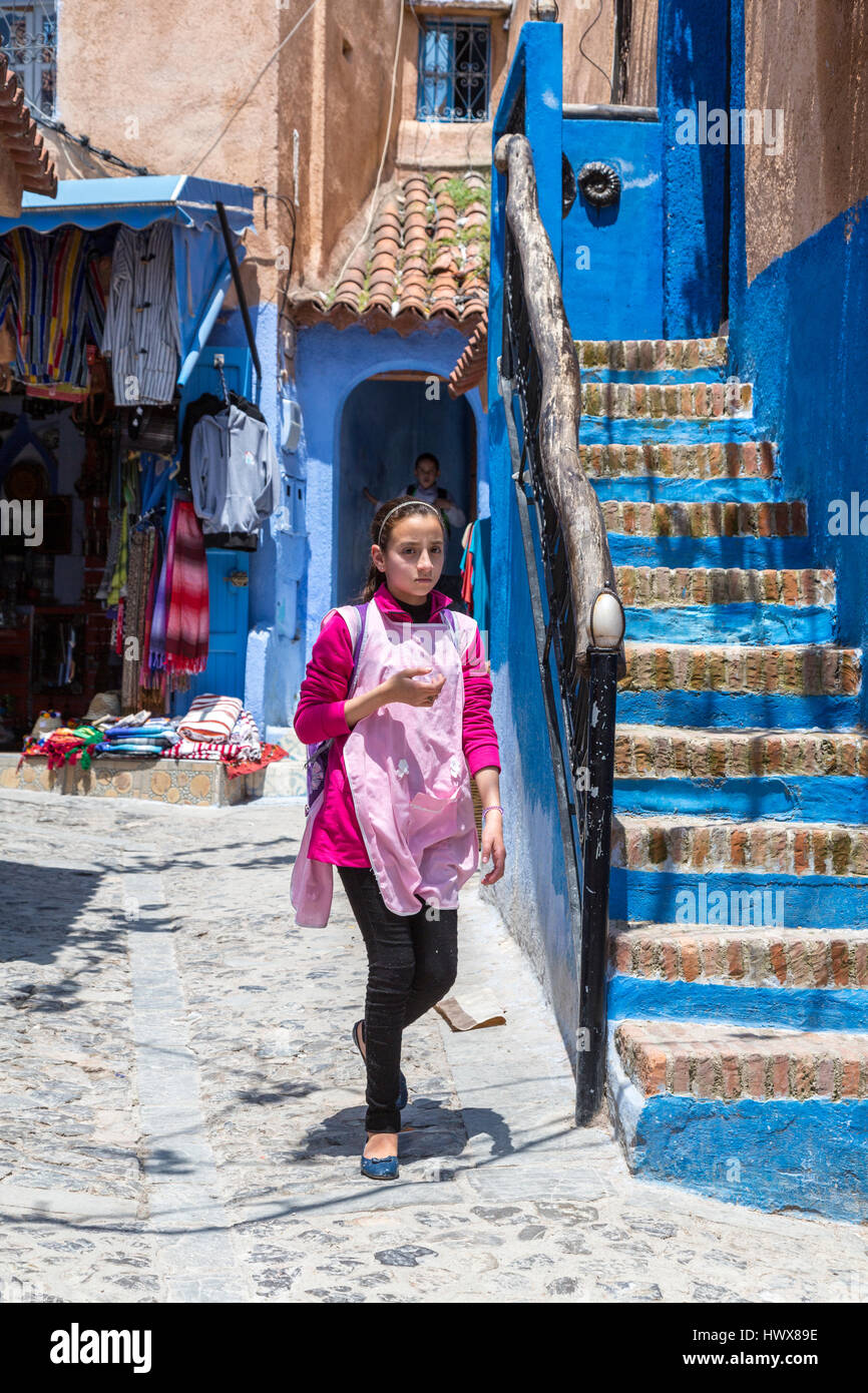 Chefchaouen, Morocco.  Teenage Girl Walking in the Medina. Stock Photo