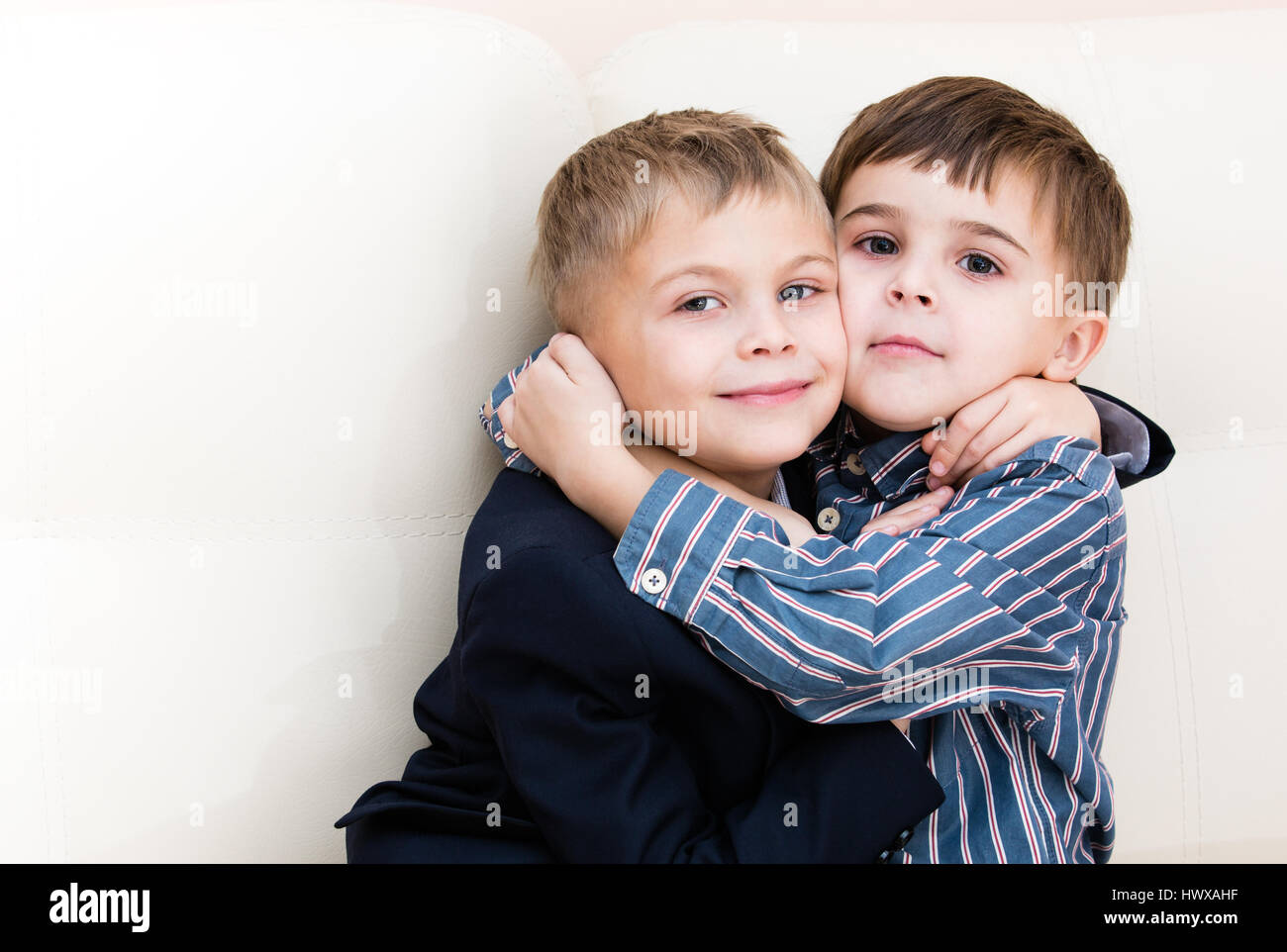 Two brothers cuddling on the couch Stock Photo Alamy