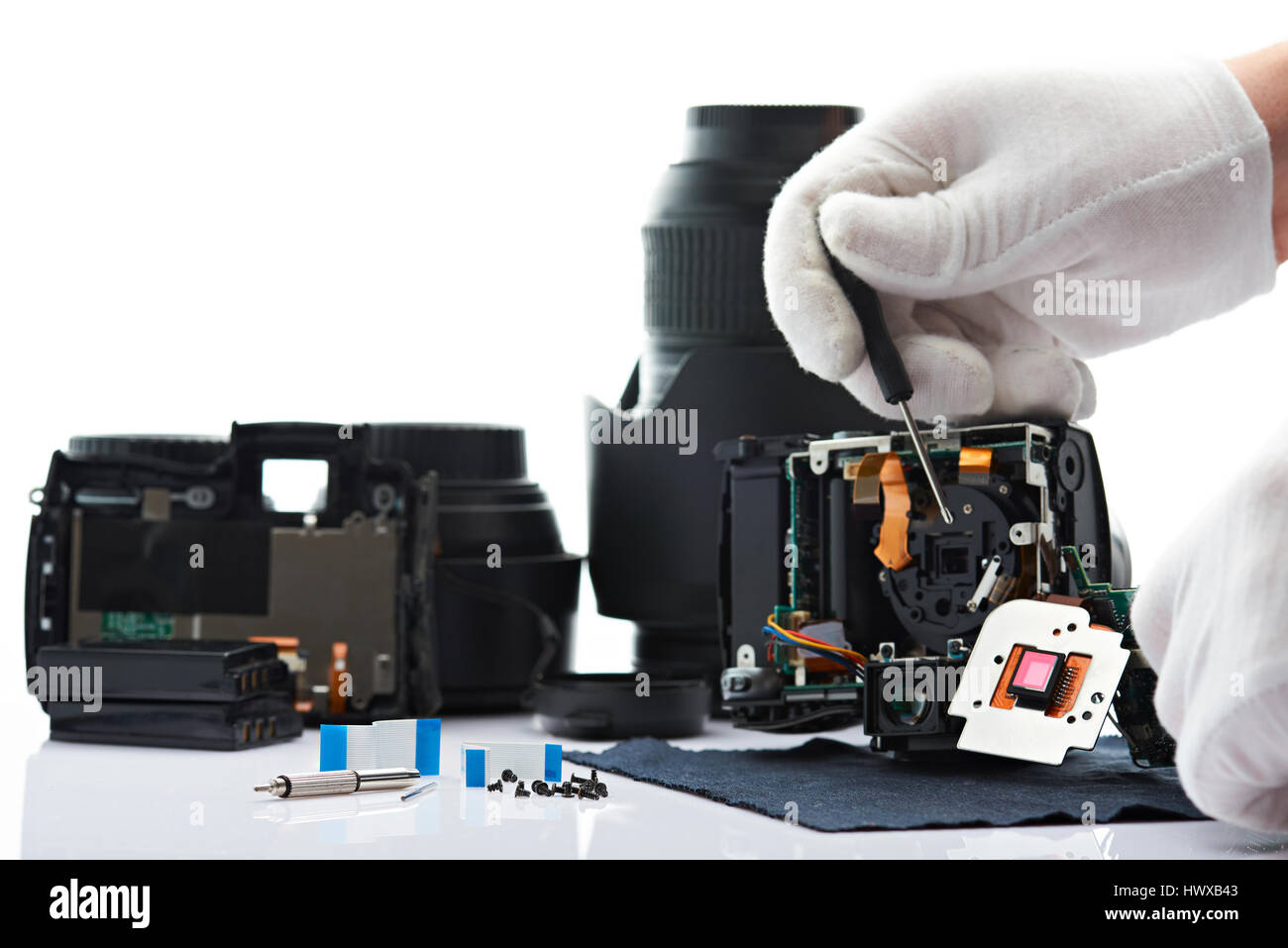 Repairing broken modern DSLR camera isolated on white background Stock