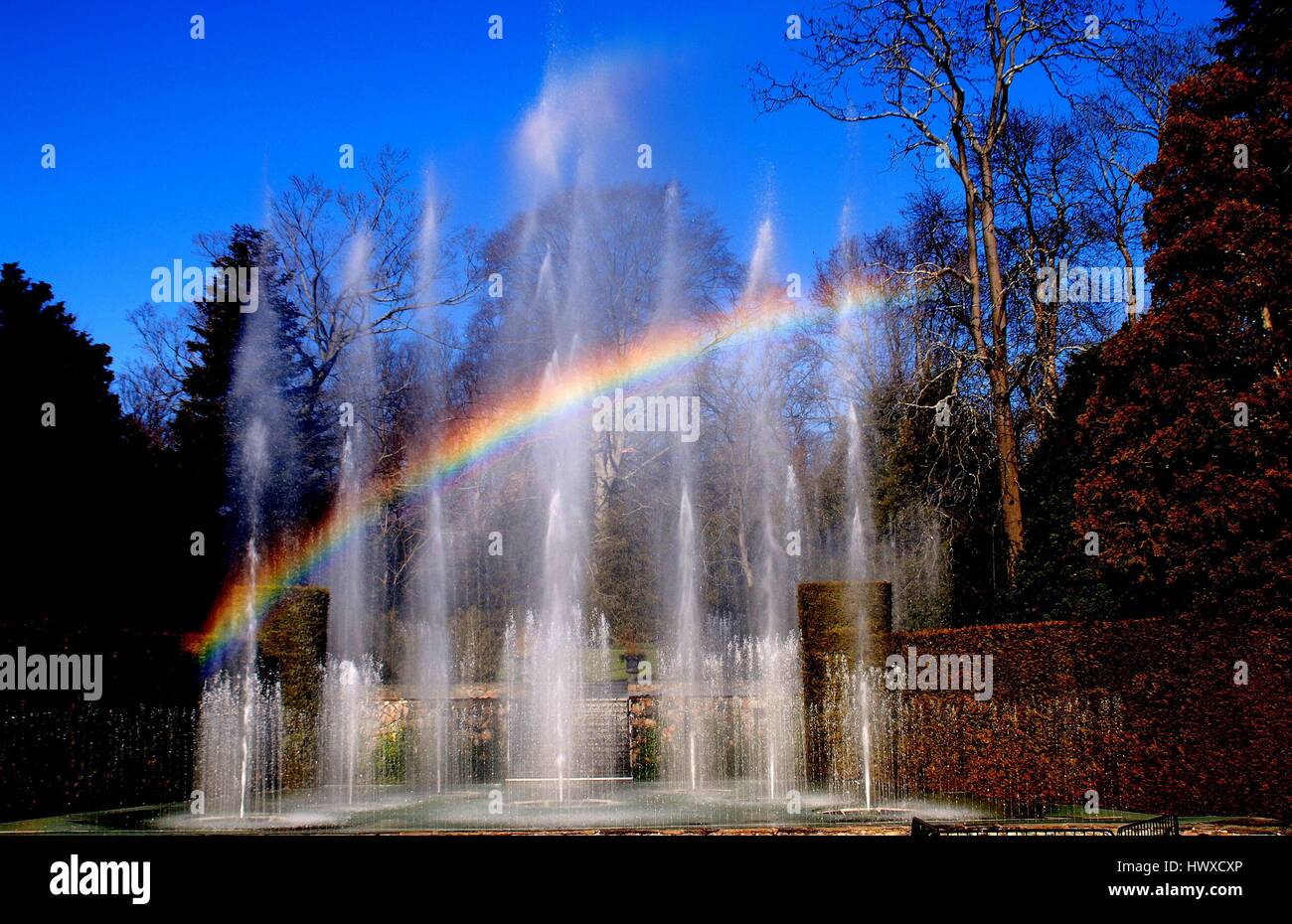 Kennett Square, Pensylvania - December 31, 2011:  A rainbow over the 229 water jets comprising the spectacular 1931 Main Fountain Garden at Longwood G Stock Photo
