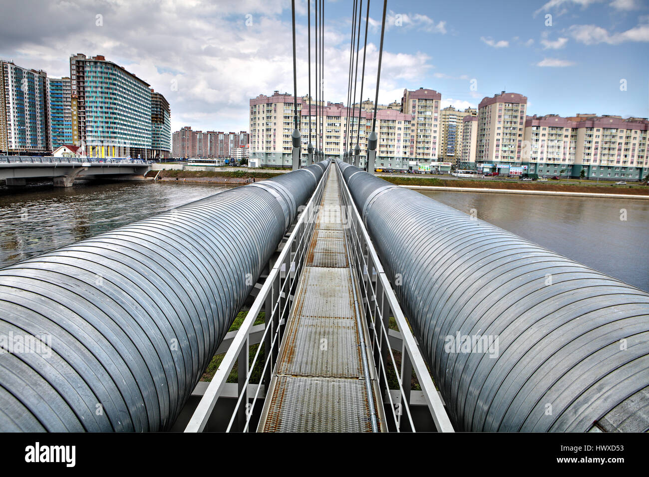 St. Petersburg, Russia - July 9, 2015: Heating duct hot water supply, cable-stayed bridge pipeline over river. Stock Photo