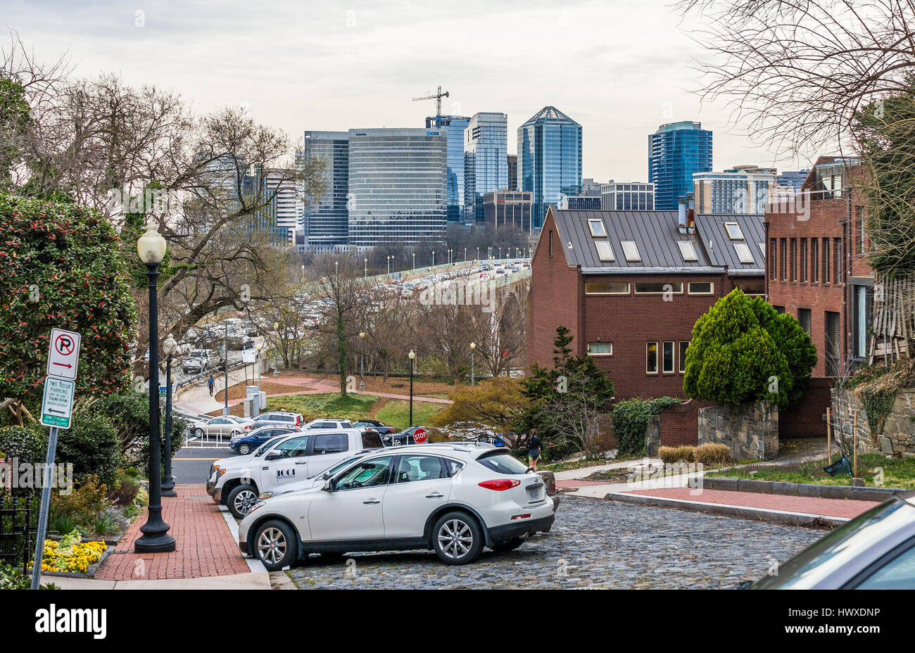 Washington DC, USA - March 20, 2017: Georgetown neighborhood with steep street with view of Key Bridge and Arlington Virginia skyline Stock Photo