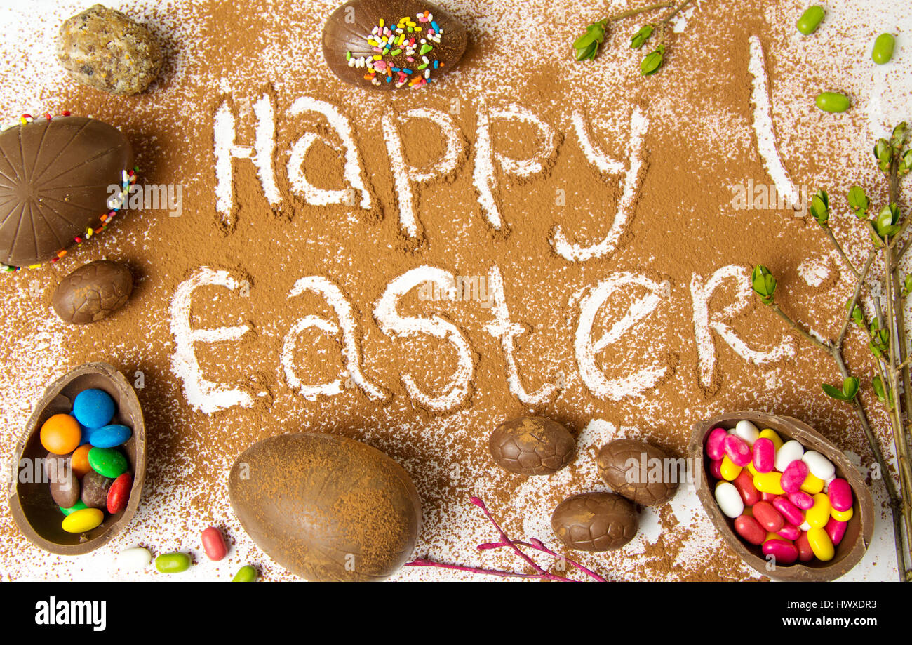 Easter note written in cacao powder with chocolate eggs Stock Photo