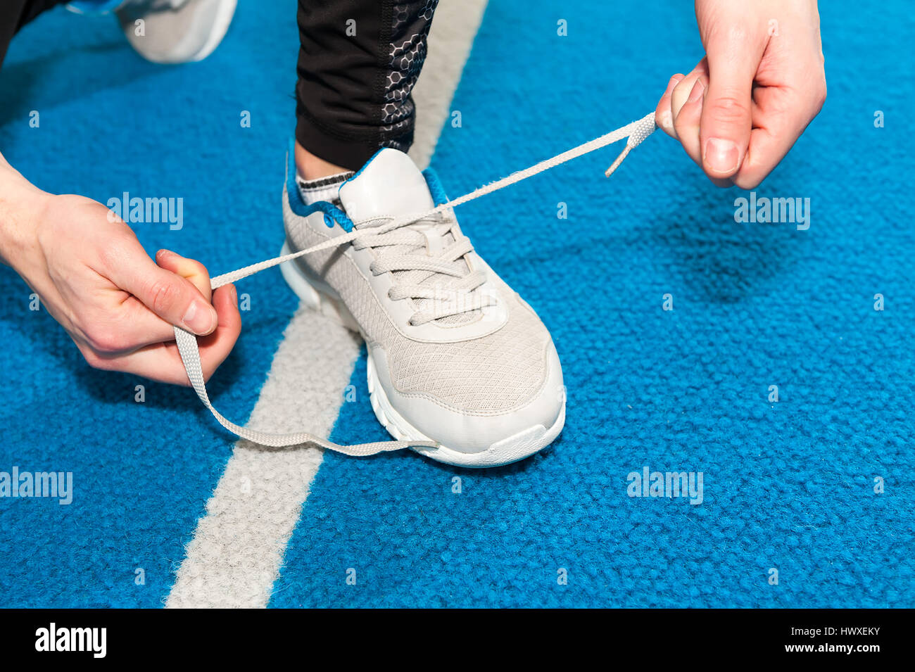 healthy lifestyle sports men tying shoelace Stock Photo
