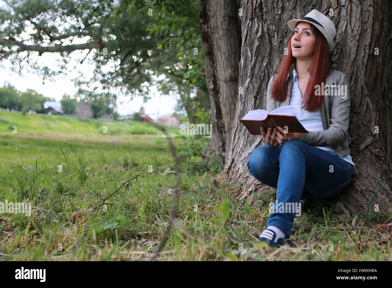 girl with book in park Stock Photo - Alamy