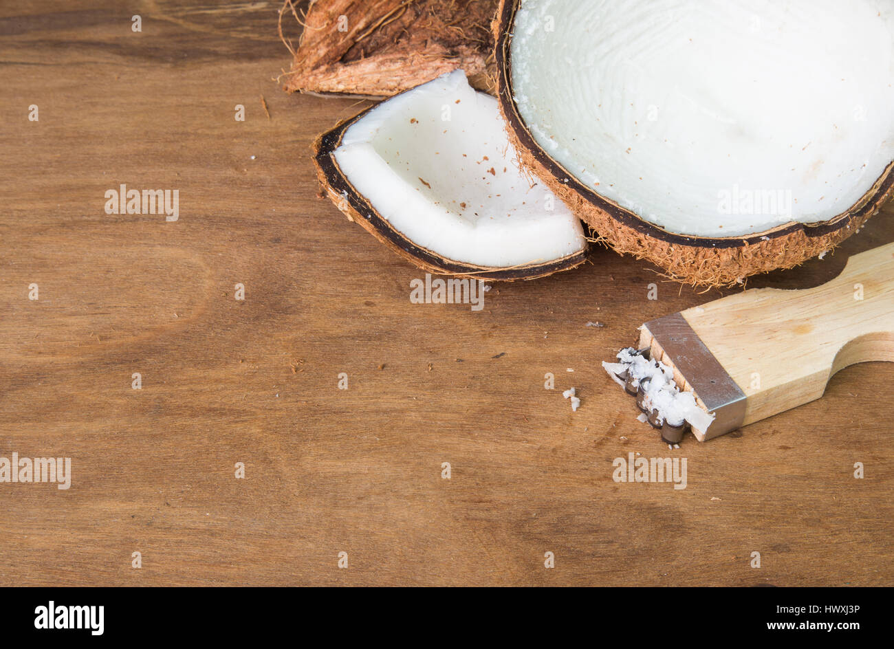 https://c8.alamy.com/comp/HWXJ3P/coconut-and-coconut-grater-on-wooden-background-HWXJ3P.jpg