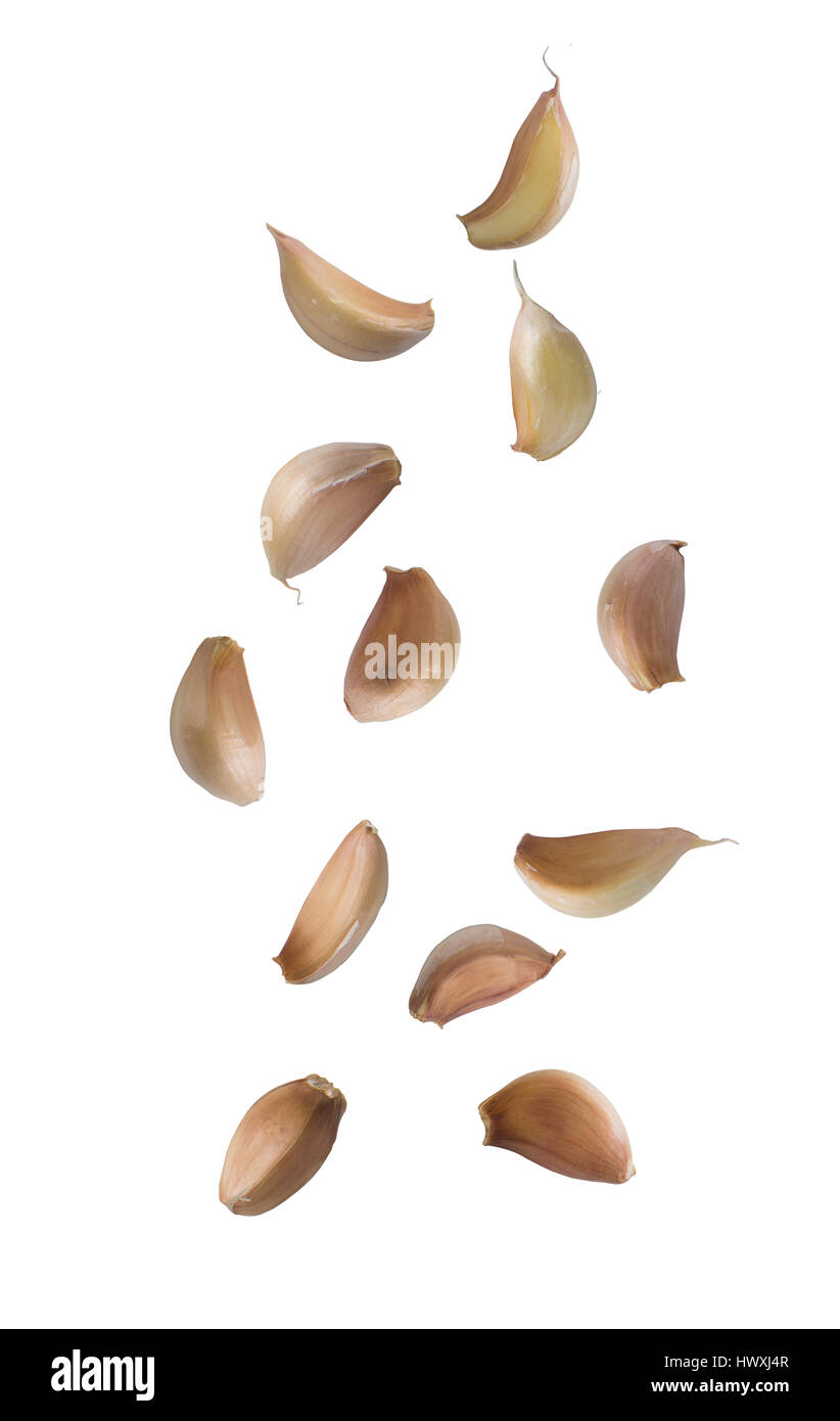 Falling garlic cloves isolated on white background Stock Photo - Alamy