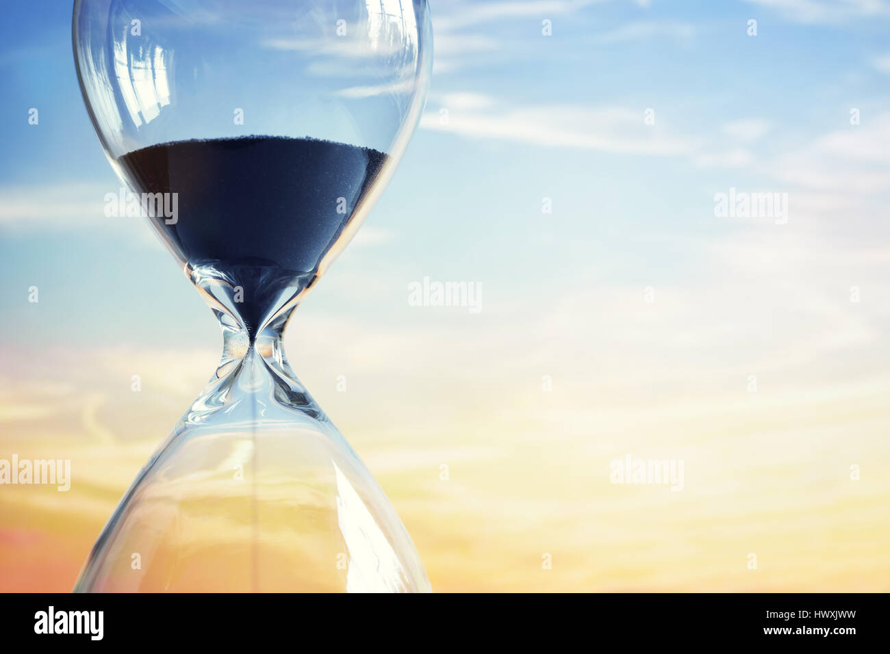 Hourglass at sunset with copy space Stock Photo