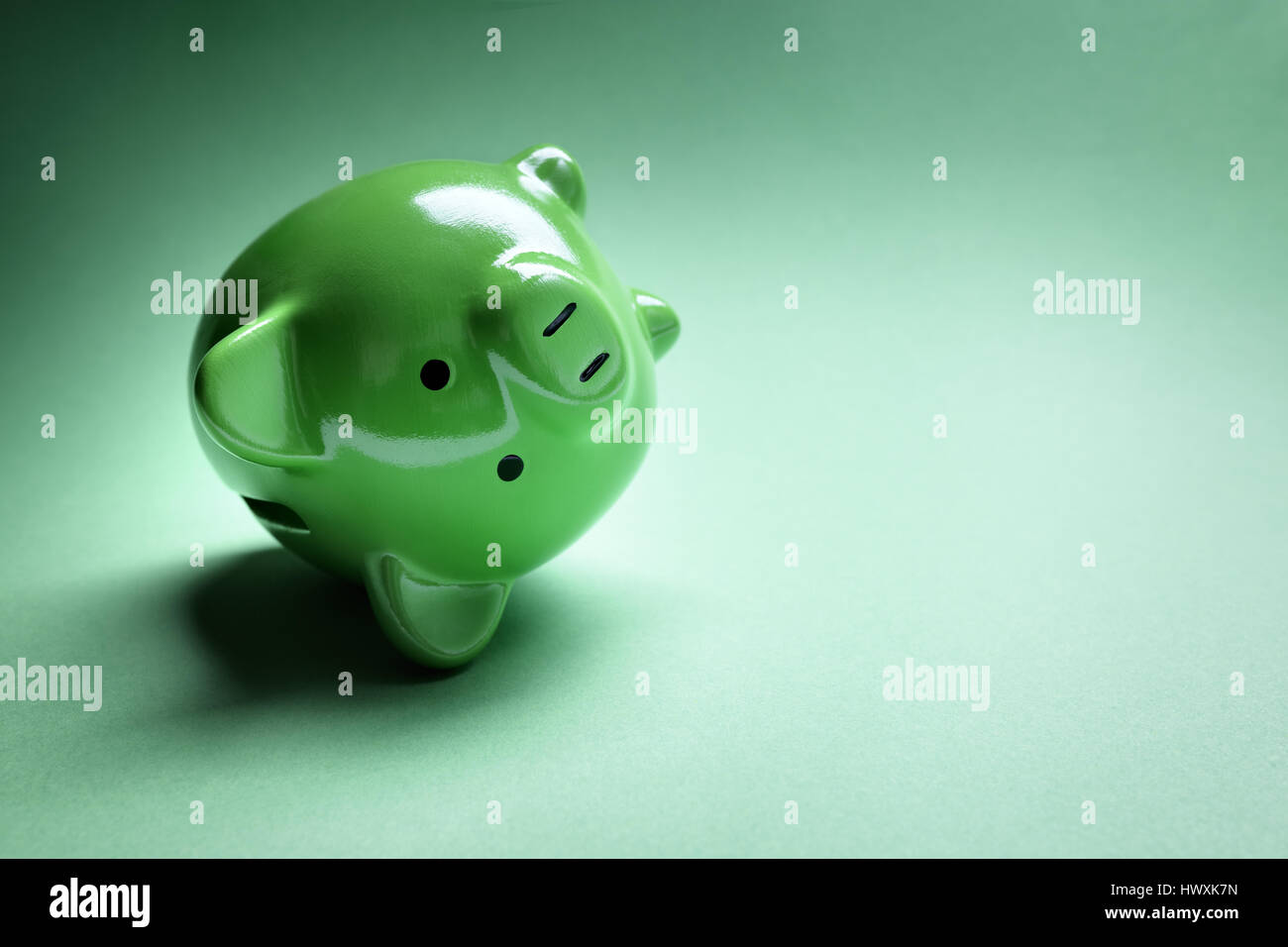 Piggy bank fallen over with financial money problems and copy space Stock Photo