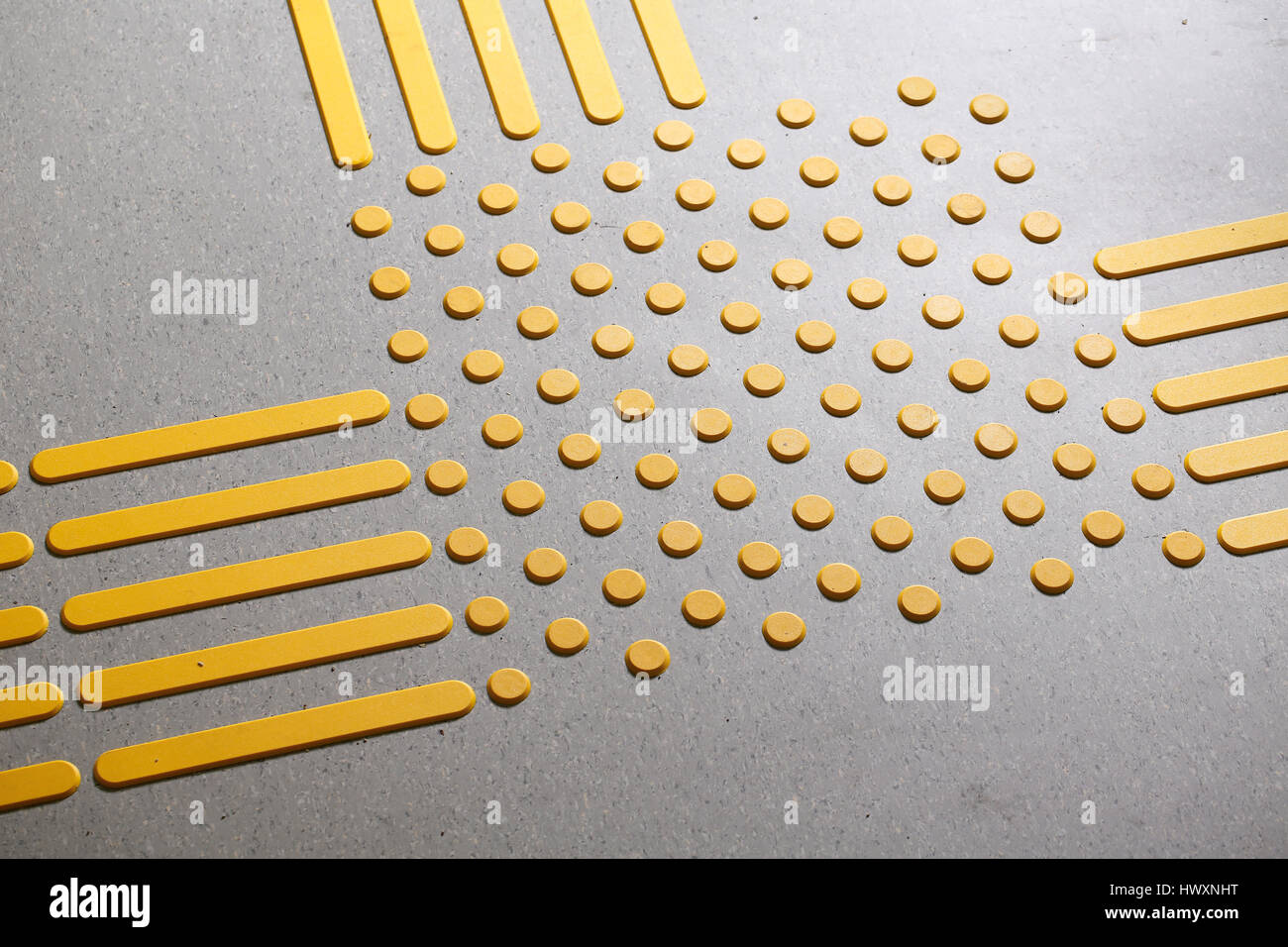 Tactile paving with textured ground surface with markings, indicators