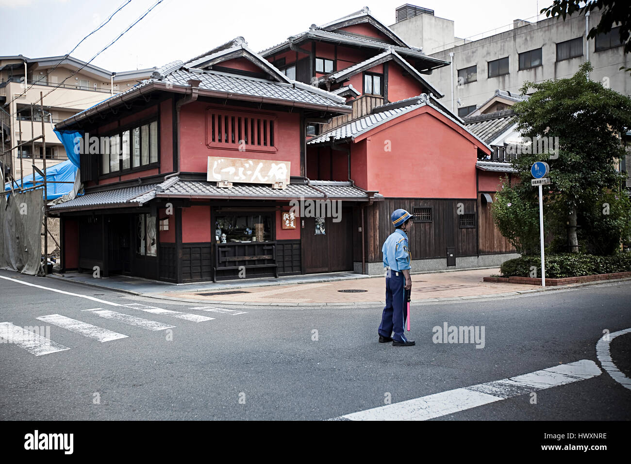 A Japanese police officer guarding the street in a neighborhood, Japan. Stock Photo